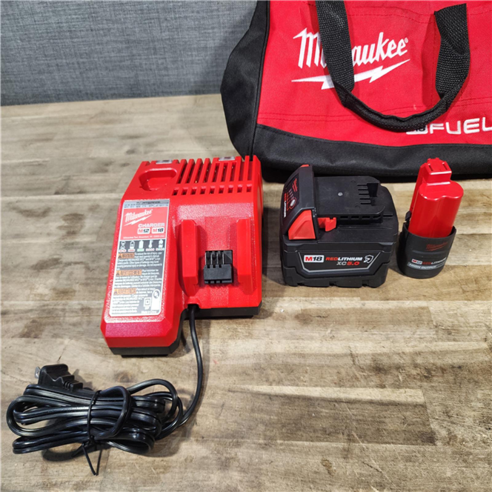 HOUSTON LOCATION - AS-IS MILWAUKEE 2 TOOL COMBO KIT W/ (2) BATTERY & CHARGER