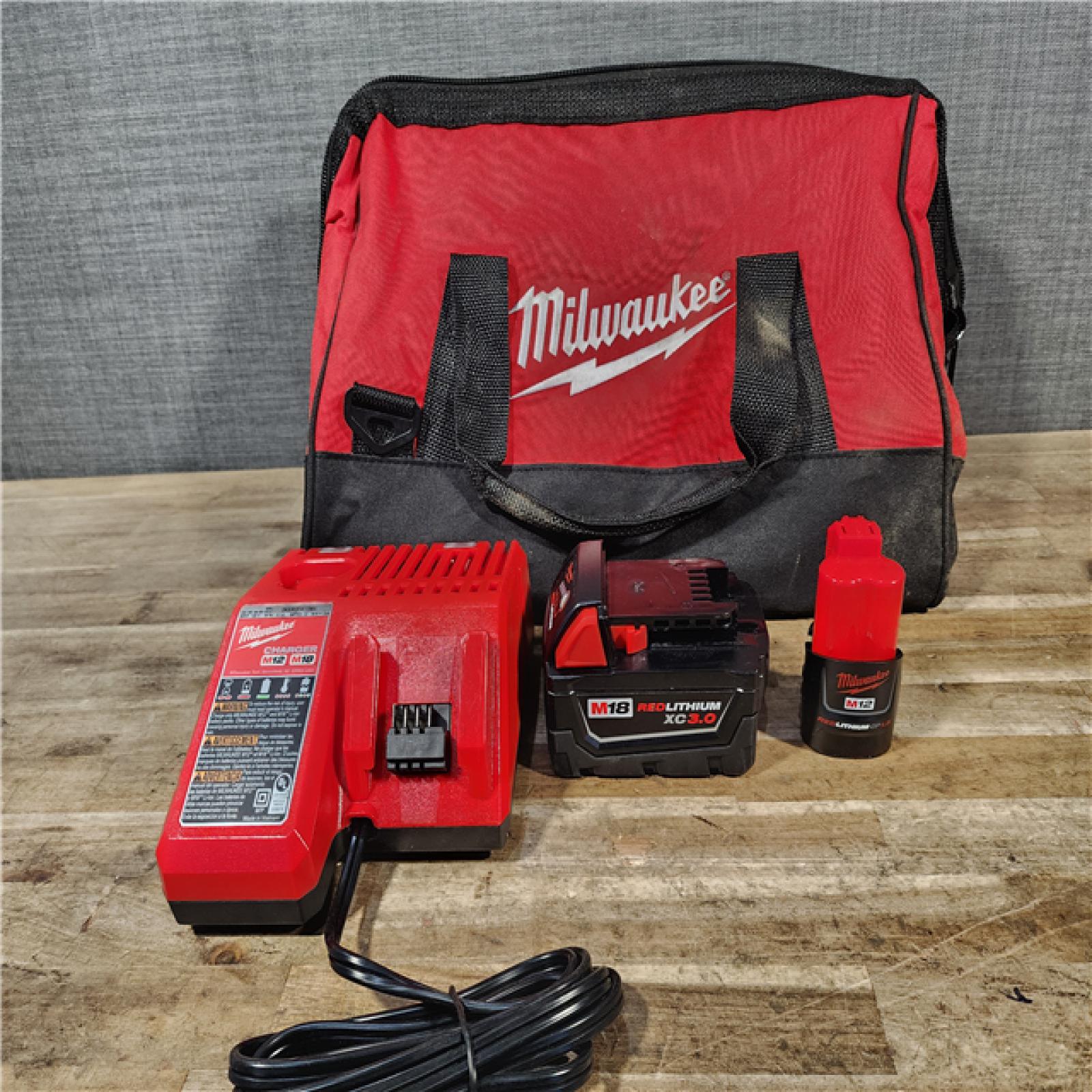 HOUSTON LOCATION - AS-IS Milwaukee 12/18V Lithium-Ion Cordless 3/8 in. Ratchet and 1/2 in. High Torque Impact Wrench with Friction Ring Combo Kit