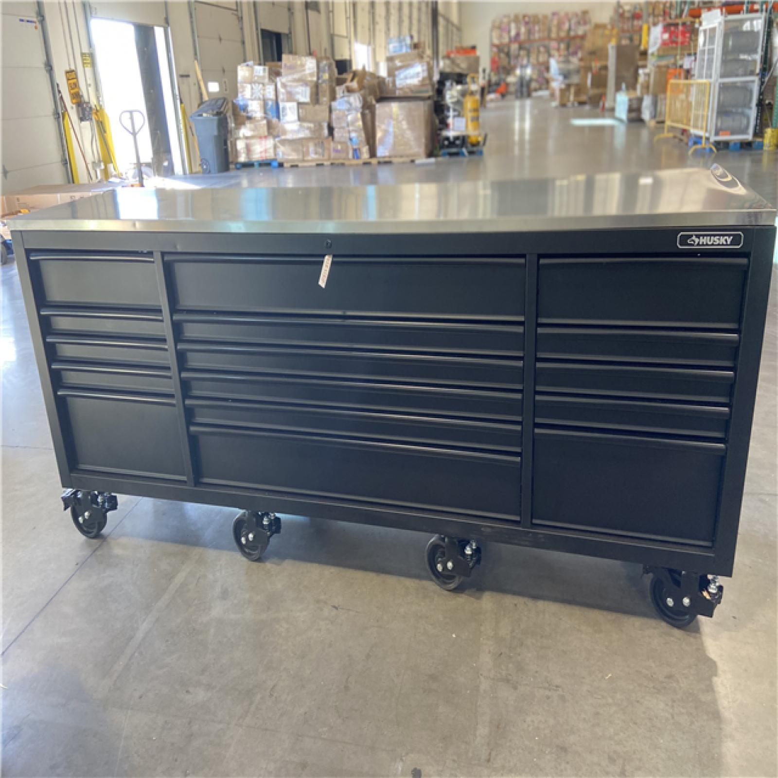 DALLAS LOCATION - Husky 96 in. W x 24 in. D 16-Drawer Heavy-Duty Mobile Workbench with Stainless Steel Top in Matte Black