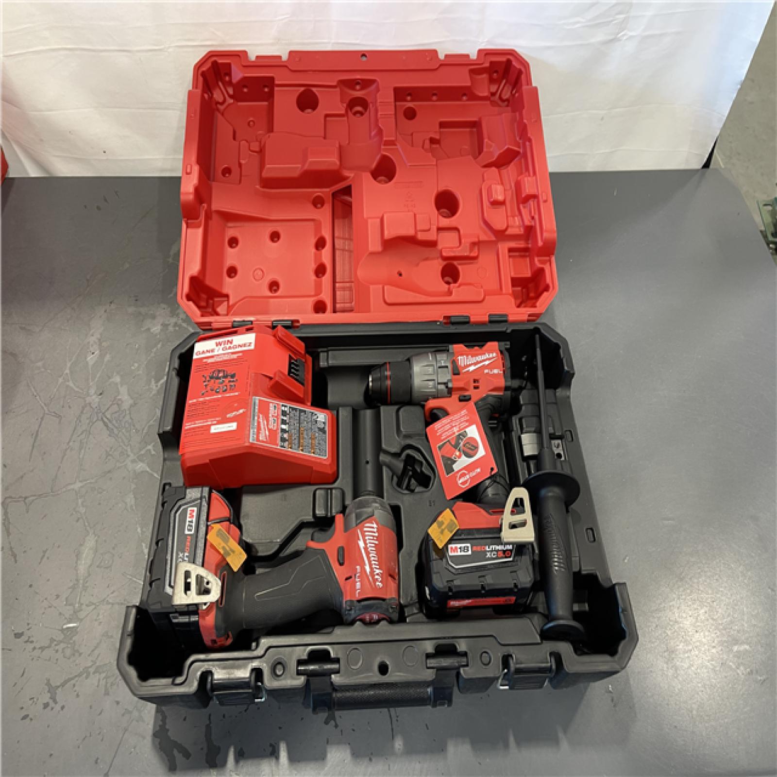 AS-IS- AS-IS - Milwaukee M18 FUEL 18V Lithium-Ion Brushless Cordless Hammer Drill and Impact Driver Combo Kit (2-Tool) with 2 Batteries