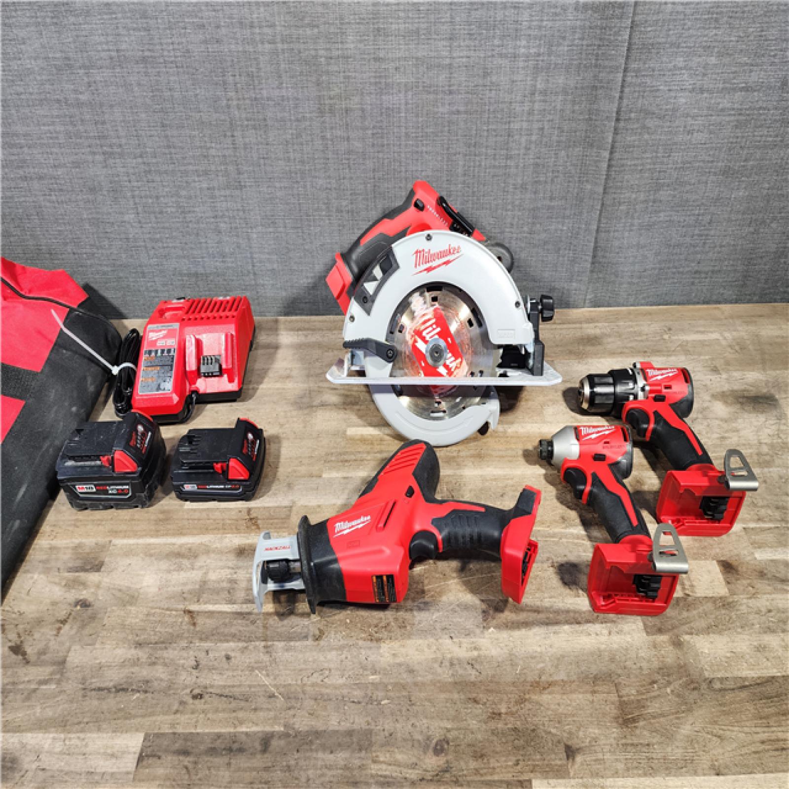HOUSTON LOCATION - AS-IS Milwaukee M18 18-Volt Lithium-Ion Brushless Cordless Combo Kit (4-Tool) with 2-Batteries  1-Charger and Tool Bag