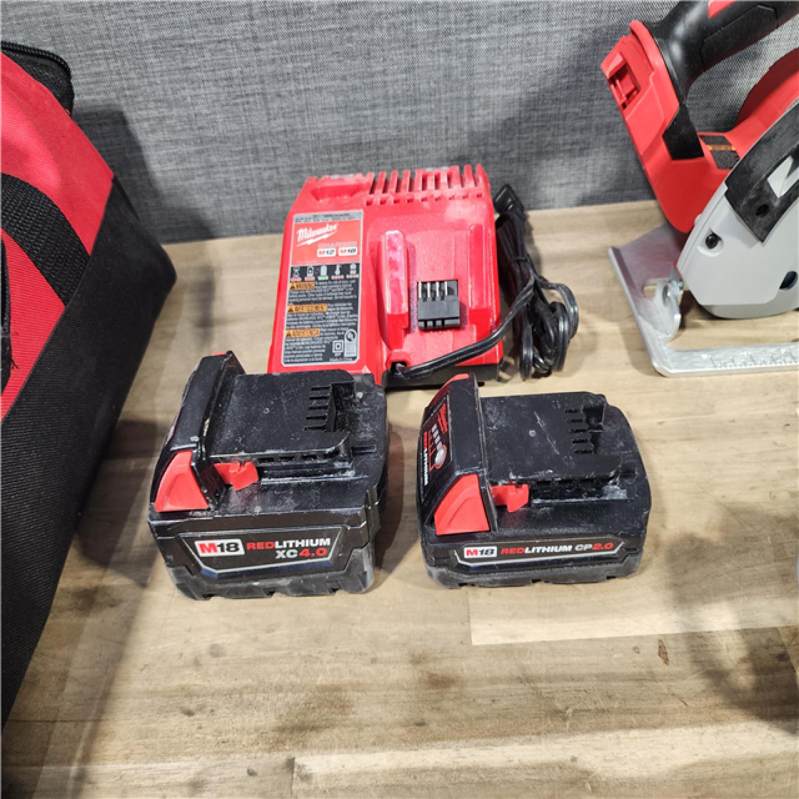 HOUSTON LOCATION - AS-IS Milwaukee M18 18-Volt Lithium-Ion Brushless Cordless Combo Kit (4-Tool) with 2-Batteries, 1-Charger and Tool Bag