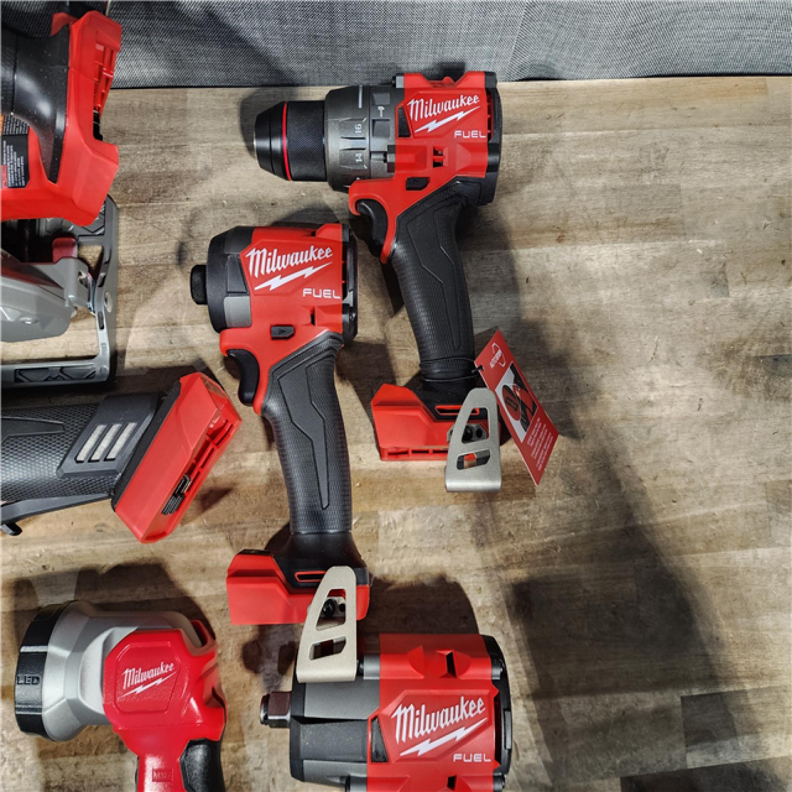 HOUSTON LOCATION - AS-IS (APPEARS LIKE NEW) Milwaukee M18 FUEL 18V Lithium-Ion Brushless Cordless Combo Kit with Two 5.0 Ah Batteries  1 Charger  2 Tool Bags (7-Tool)
