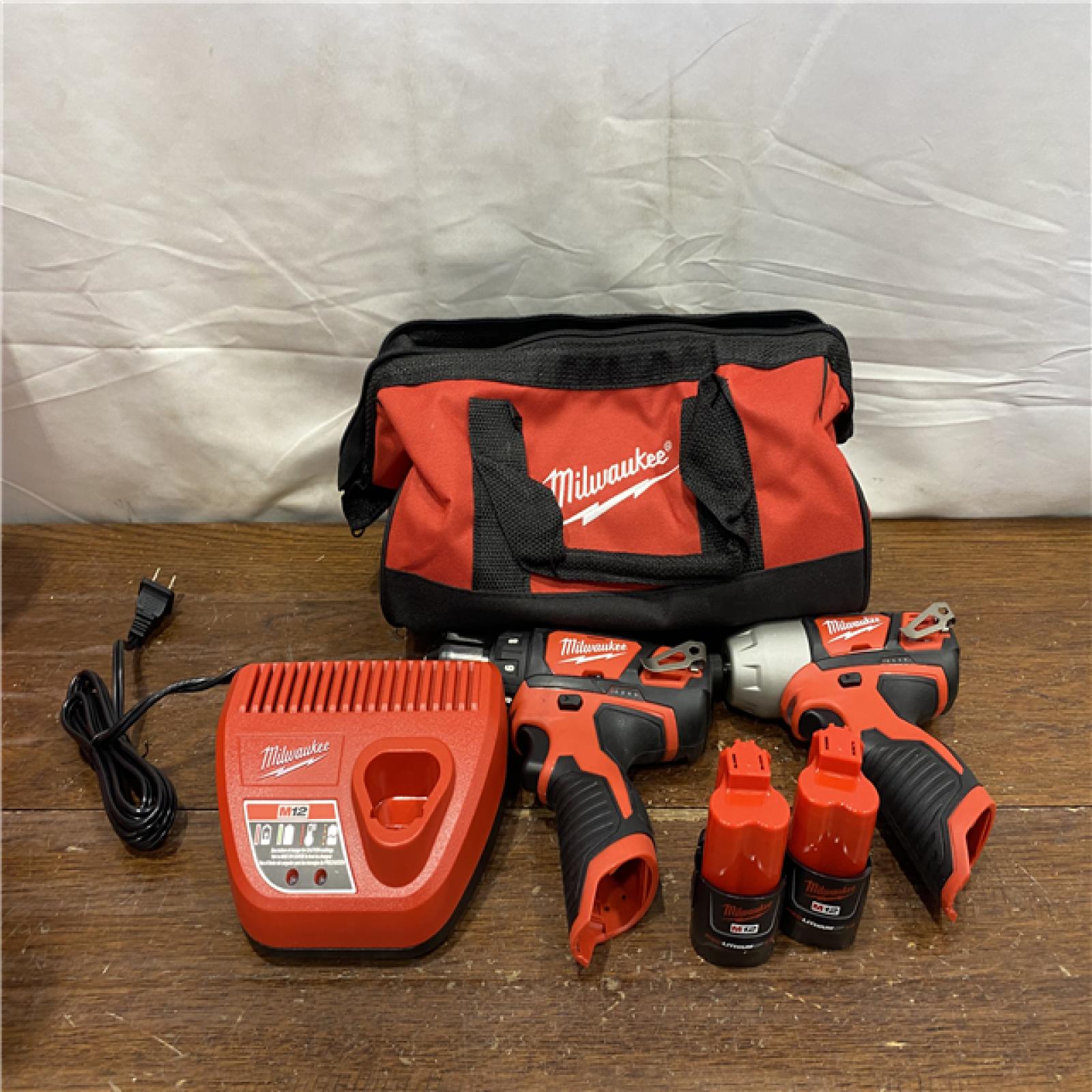 AS-IS Milwaukee 2494-22 M12 Cordless Combination 3/8  Drill / Driver and 1/4  Hex Impact Driver Dual Power Tool Kit (2 Lithium Ion Batteries  Charger  and B