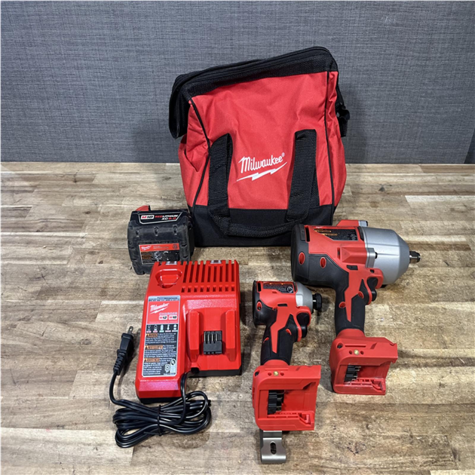 Houston Location AS-IS Milwaukee Impact Wrench and Impact Driver and Battery with Charger