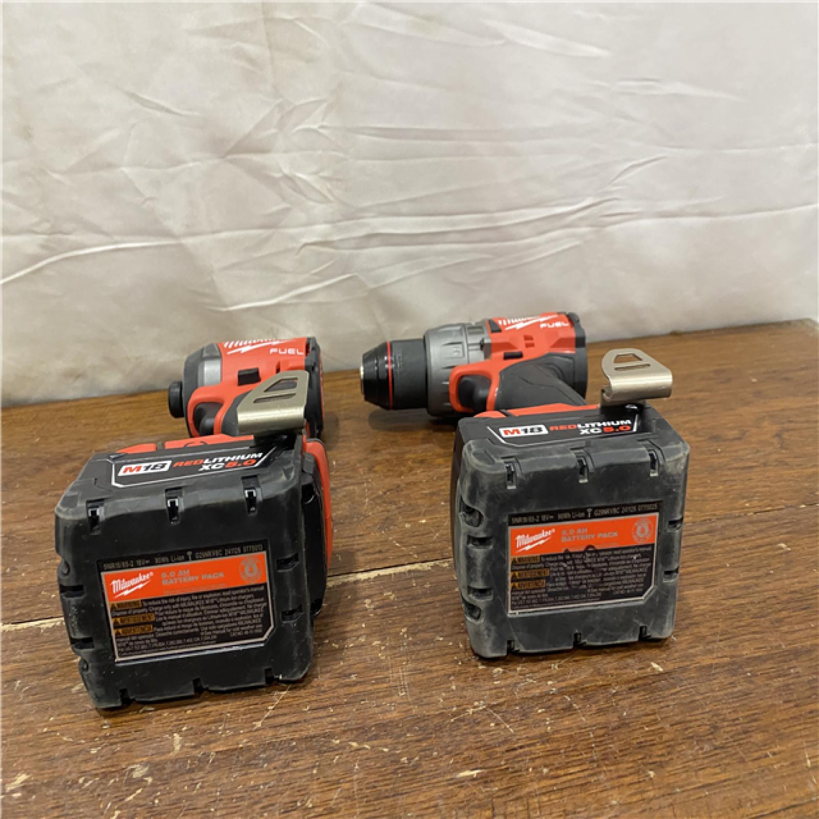 AS-IS MILWAUKEE M18 FUEL 18V Lithium-Ion Brushless Cordless Hammer Drill and Impact Driver Combo Kit (2-Tool) with 2 Batteries