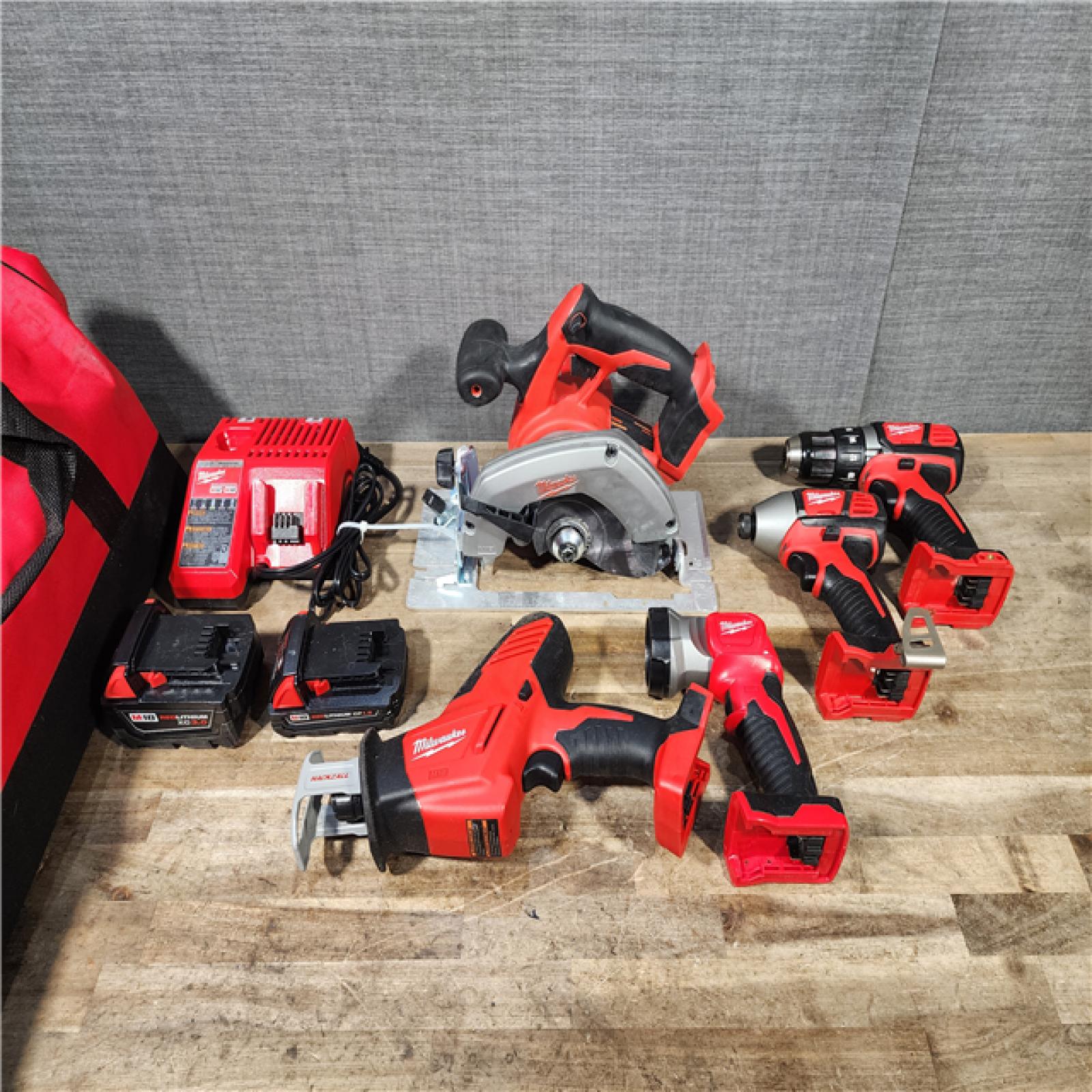 HOUSTON LOCATION - AS-IS Milwaukee M18 18-Volt Lithium-Ion Cordless Combo Tool Kit (5-Tool) with (1) 3.0Ah and (1) 1.5Ah Battery  (1) Charger  (1) Tool Bag