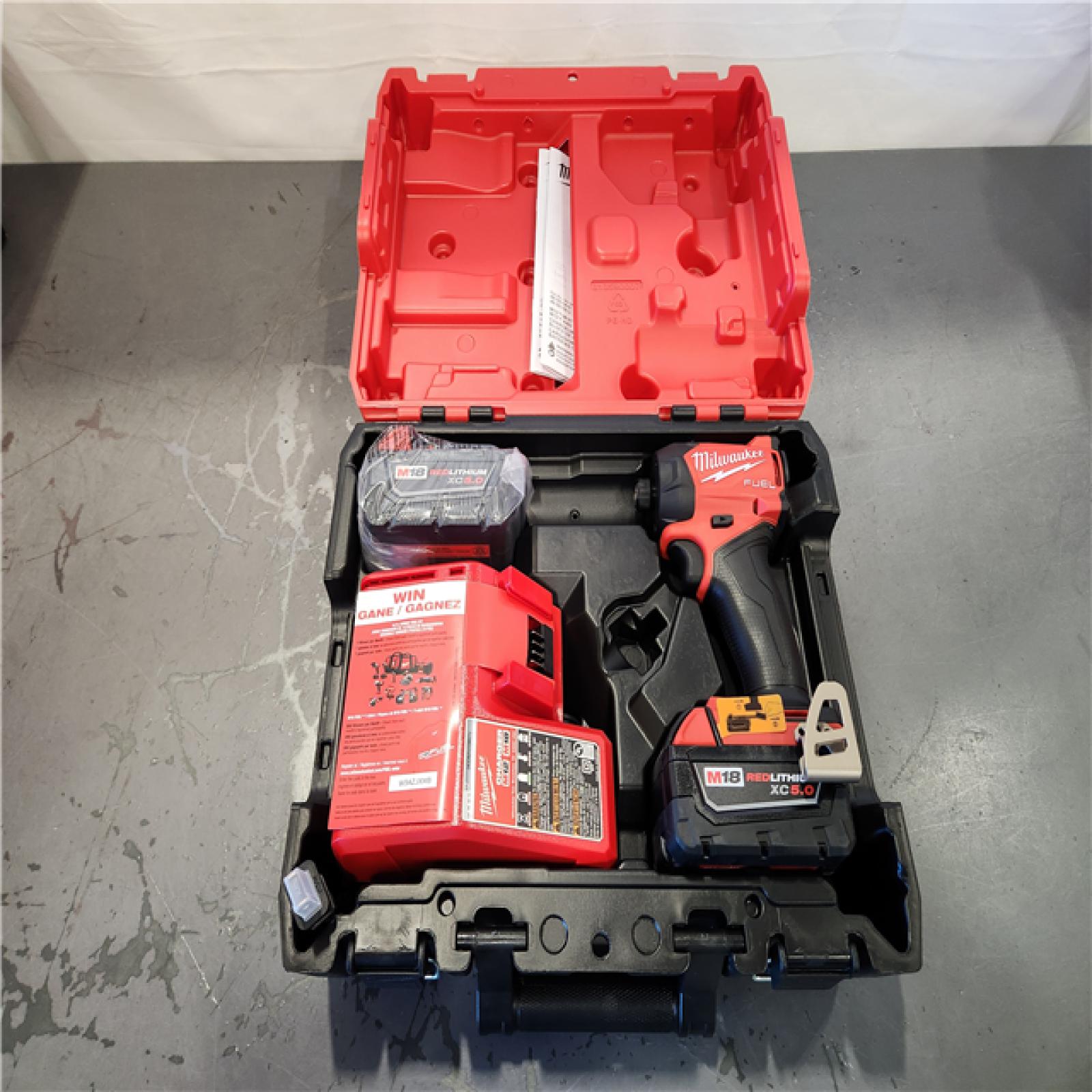 AS-IS-  Milwaukee FUEL SURGE 18V Lithium-Ion Brushless Cordless 1/4 in. Hex Impact Driver with (2) 5.0 Ah Battery and Charger