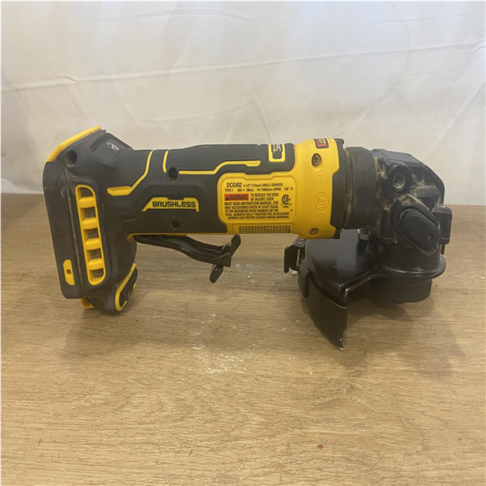 AS-IS DEWALT ATOMIC 20V MAX Cordless 4-1/2 in. Angle Grinder with Paddle Switch (Tool Only)