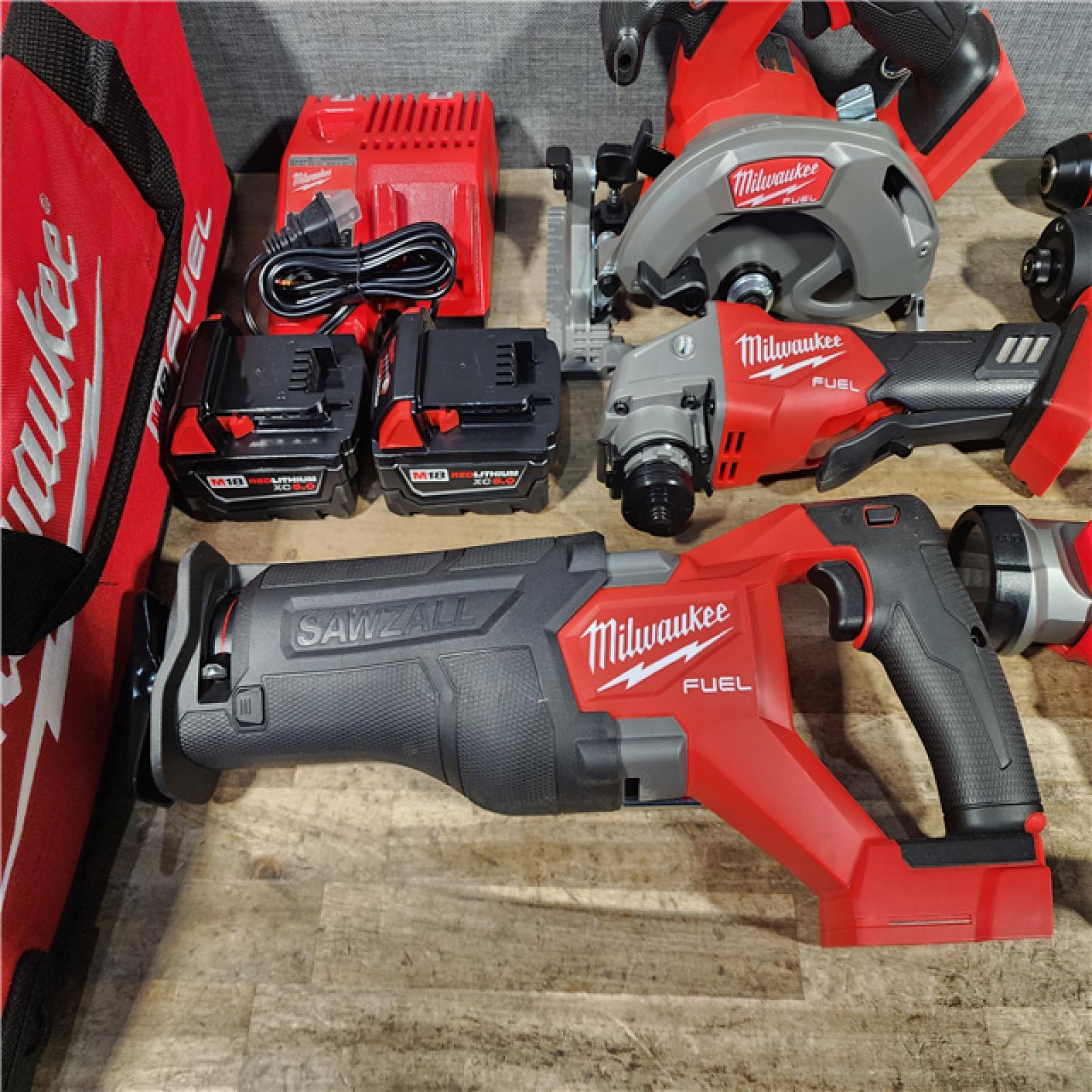 HOUSTON LOCATION - AS-IS (APPEARS LIKE NEW) Milwaukee M18 FUEL 18V Lithium-Ion Brushless Cordless Combo Kit with Two 5.0 Ah Batteries  1 Charger  2 Tool Bags (7-Tool)