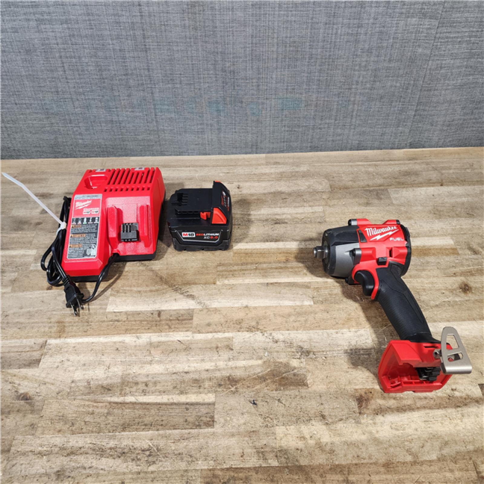 HOUSTON LOCATION - AS-IS Milwaukee M18 18V Fuel 1/2  Mid-Torque Impact Wrench Cordless Lithium-Ion Brushless with Friction Ring W/ BATTERY & CHARGER