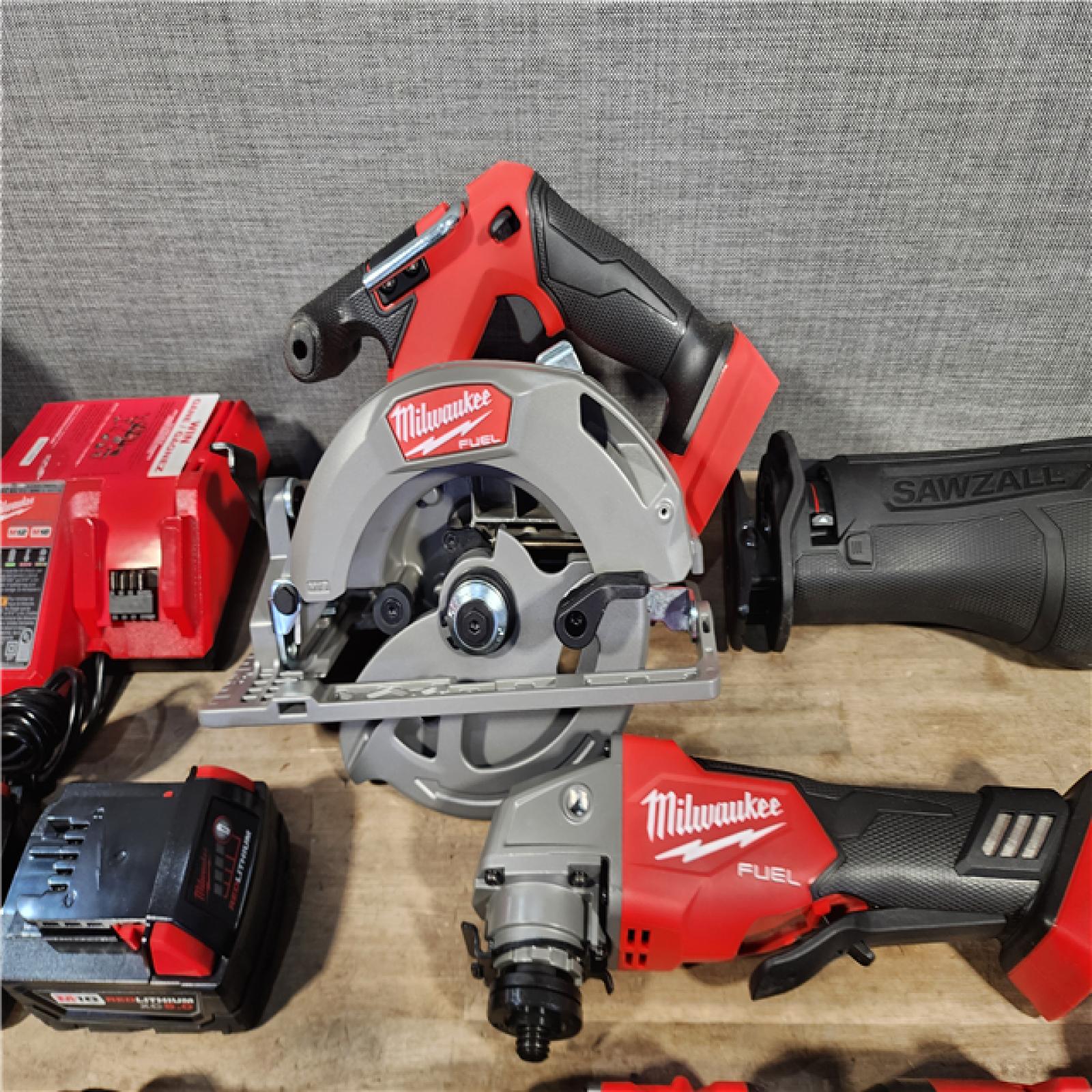 HOUSTON LOCATION - AS-IS (APPEARS LIKE NEW) Milwaukee M18 FUEL 18V Lithium-Ion Brushless Cordless Combo Kit with Two 5.0 Ah Batteries  1 Charger  2 Tool Bags (7-Tool)