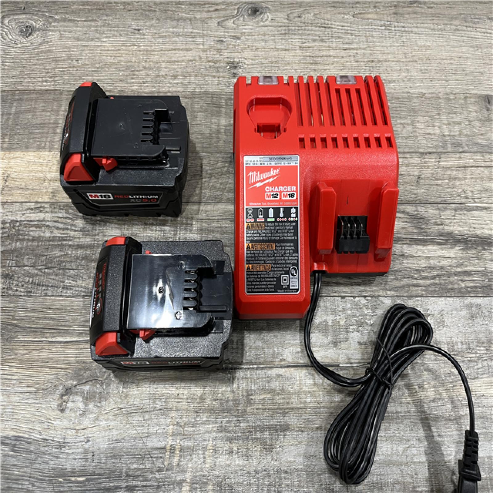 AS-IS Milwaukee 18-Volt Lithium-Ion XC Starter Kit with (2) 5.0Ah Batteries and Charger