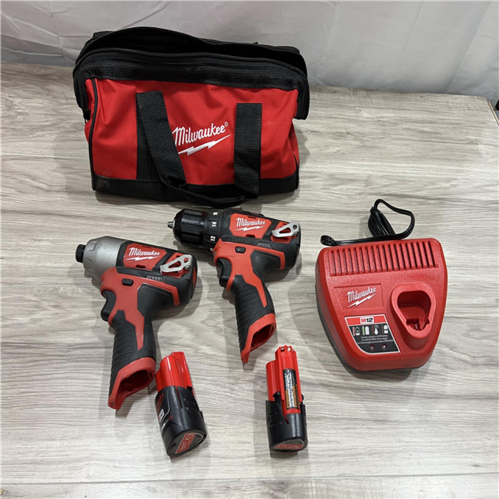 AS-IS Milwaukee 2494-22 M12 Cordless Combination 3/8 Drill / Driver and 1/4 Hex Impact Driver Dual Power Tool Kit (2 Lithium Ion Batteries  Charger  and B