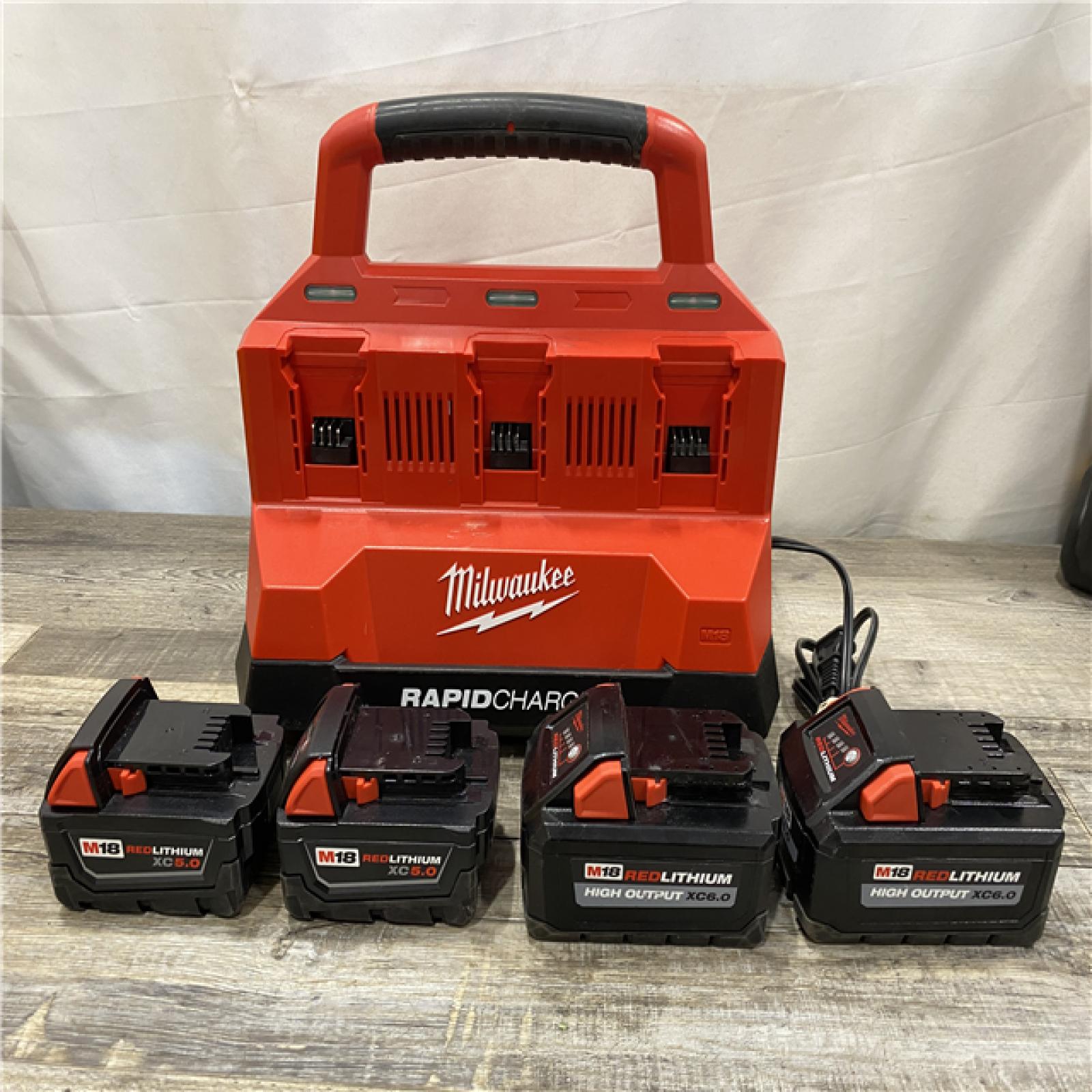 AS-IS Milwaukee 18-Volt Lithium-Ion Battery Pack (2) 5.0Ah and High Output Battery Pack (2) 6.0Ah with PACKOUT 6-Port Rapid Charger