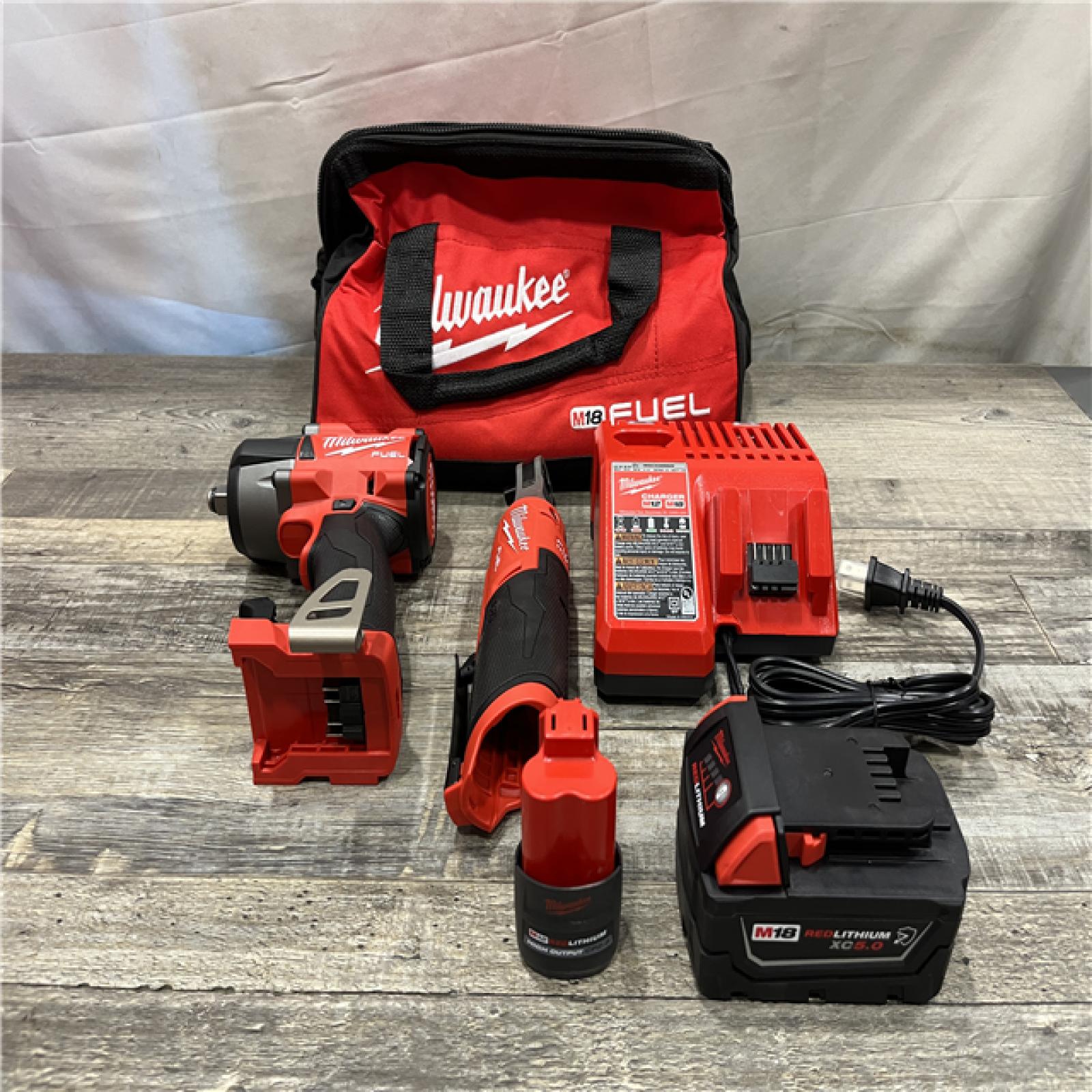 AS-IS Milwaukee FUEL 18V Cordless Mid Torque 1/2 in. Impact Wrench w/ 12 FUEL 3/8 in. Ratchet Combo Kit