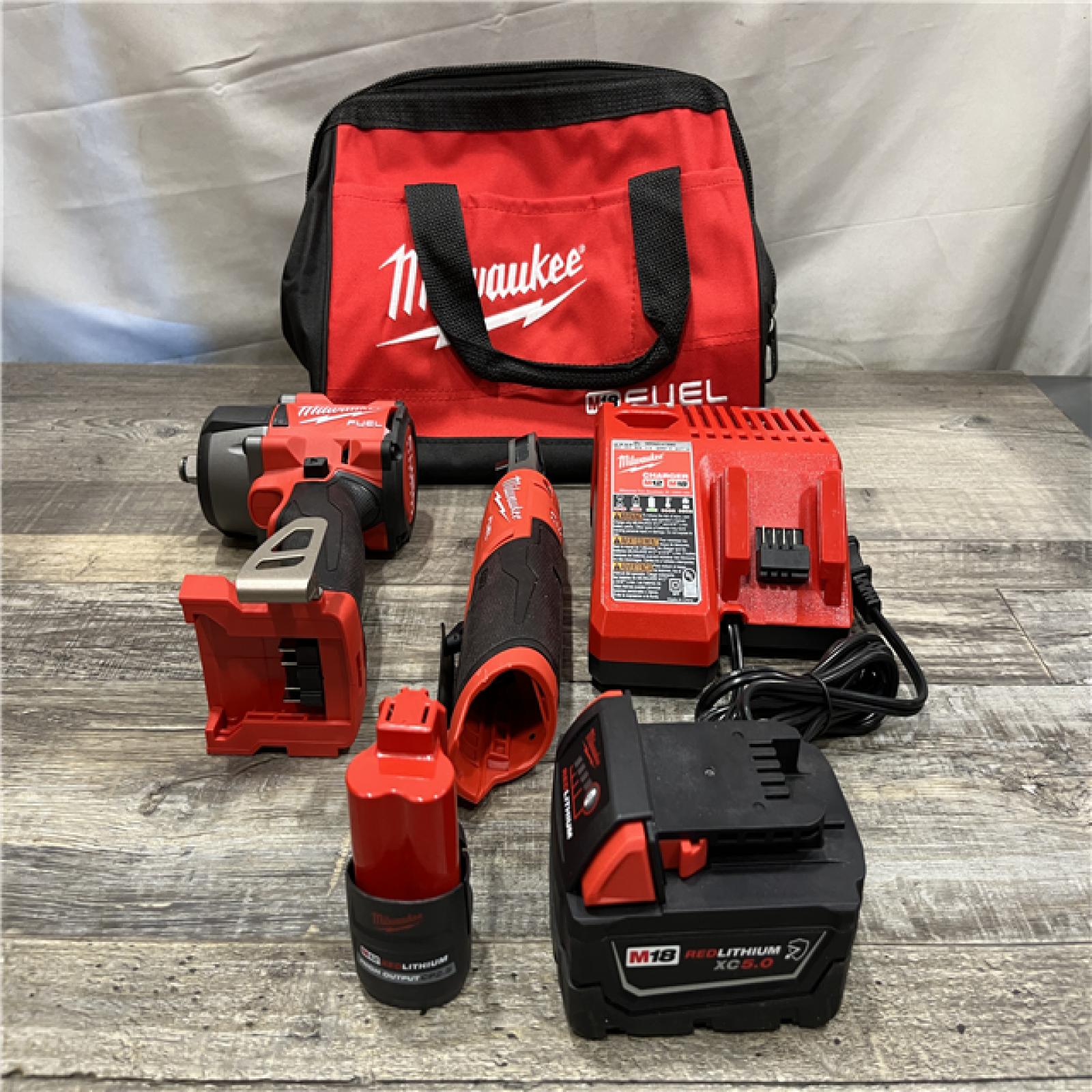 AS-IS Milwaukee FUEL 18V Cordless Mid Torque 1/2 in. Impact Wrench w/ 12 FUEL 3/8 in. Ratchet Combo Kit