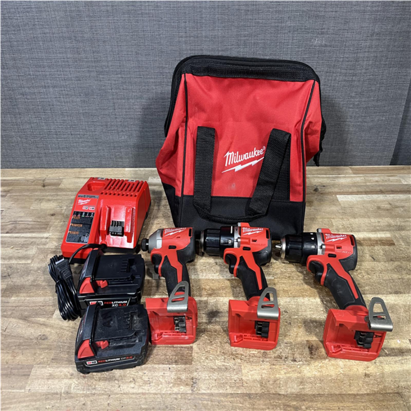 Houston Location AS-IS Milwaukee Hammer Drill Driver and Drill Driver and Impact Driver and Batteries QTY/2 with Charger