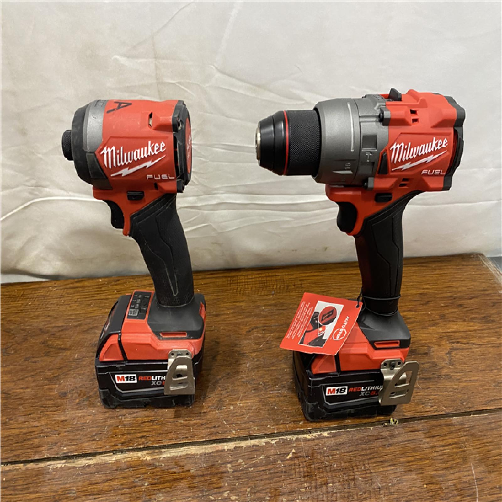 AS-IS MILWAUKEE M18 FUEL 18V Lithium-Ion Brushless Cordless Hammer Drill and Impact Driver Combo Kit (2-Tool) with 2 Batteries