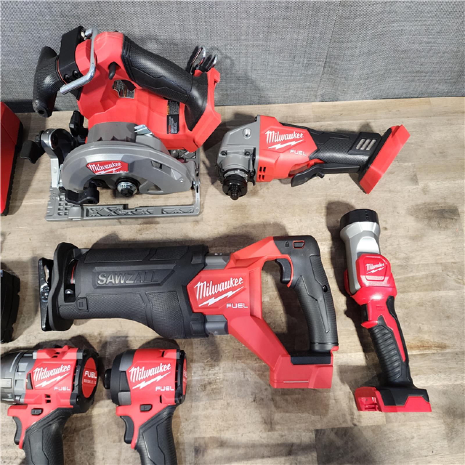 HOUSTON LOCATION - AS-IS (APPEARS LIKE NEW) Milwaukee M18 FUEL 18V Lithium-Ion Brushless Cordless Combo Kit with Two 5.0 Ah Batteries  1 Charger  2 Tool Bags (7-Tool)