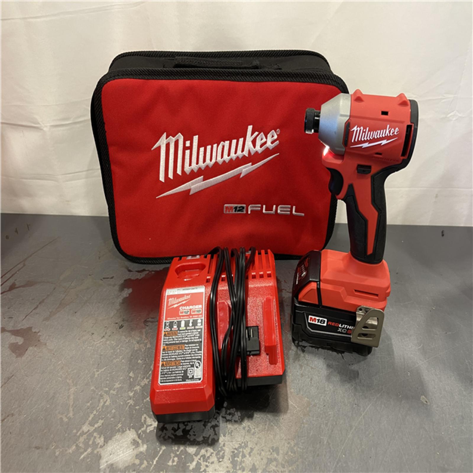 AS-IS - Milwaukee  M18 18-Volt Lithium-Ion Brushless Cordless 1/4 in. Compact Impact Driver Kit