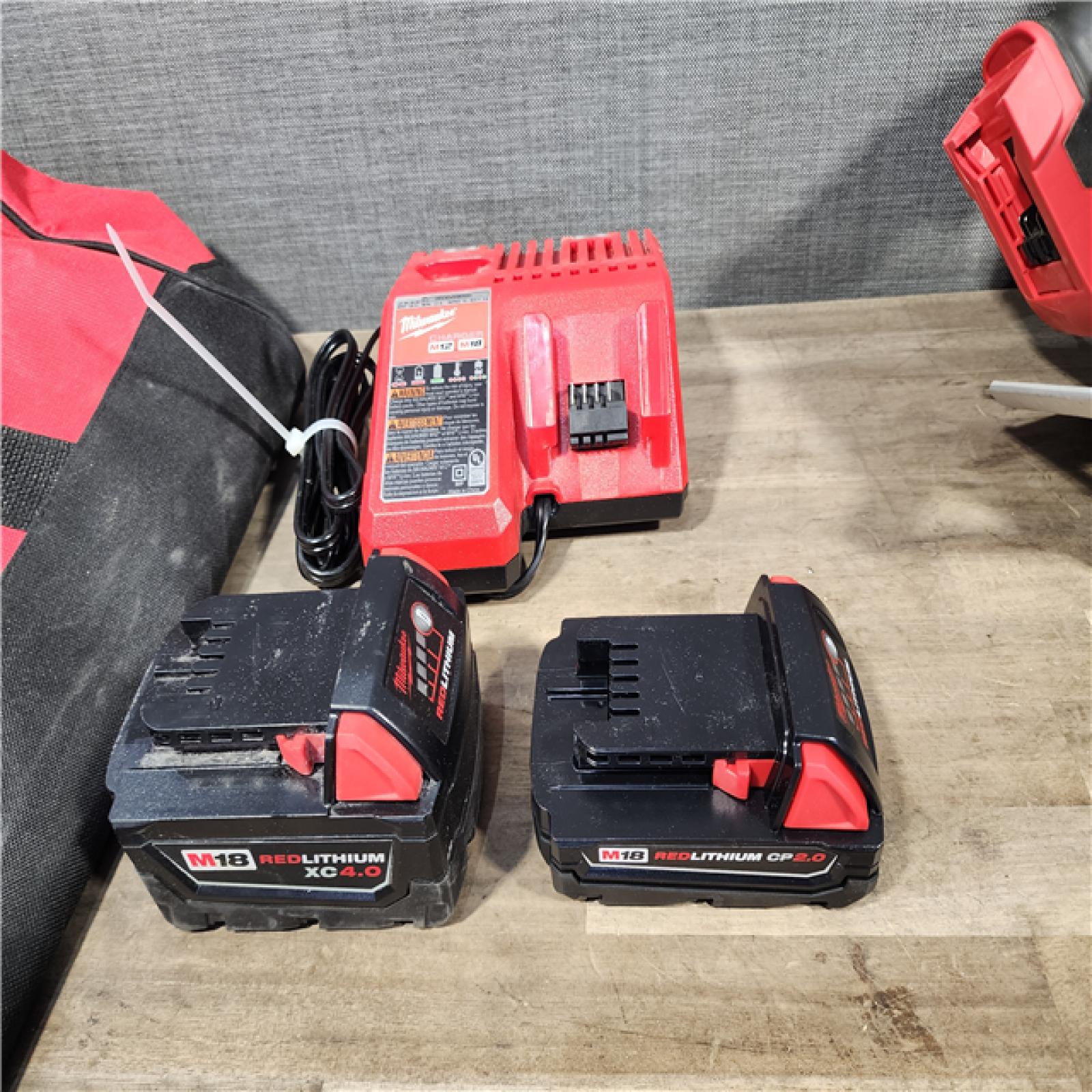 HOUSTON LOCATION - AS-IS Milwaukee M18 18-Volt Lithium-Ion Brushless Cordless Combo Kit (4-Tool) with 2-Batteries  1-Charger and Tool Bag