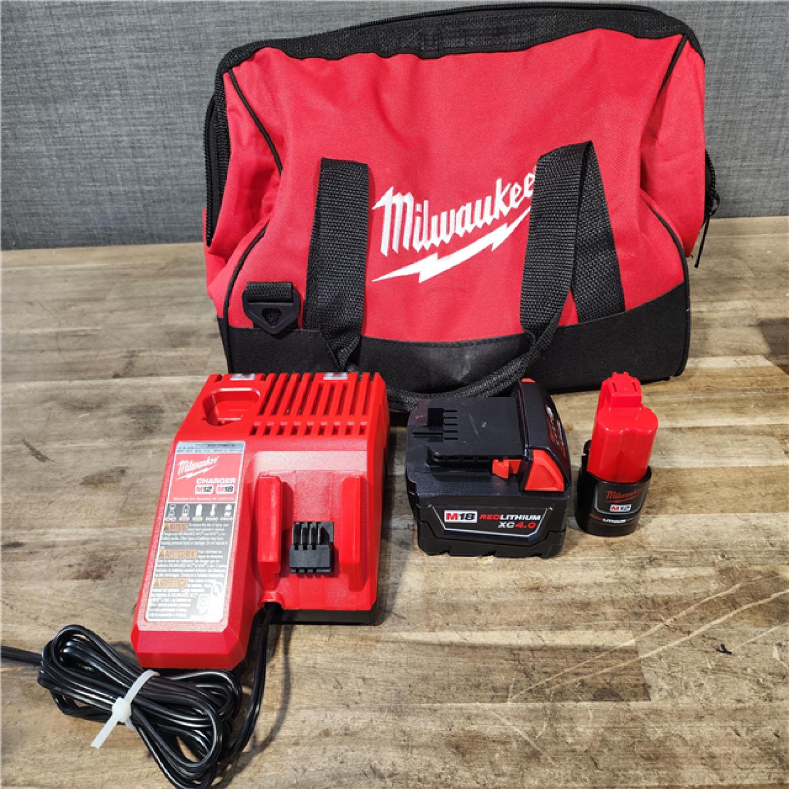 HOUSTON LOCATION - AS-IS Milwaukee 12/18V Lithium-Ion Cordless 3/8 in. Ratchet and 1/2 in. High Torque Impact Wrench with Friction Ring Combo Kit