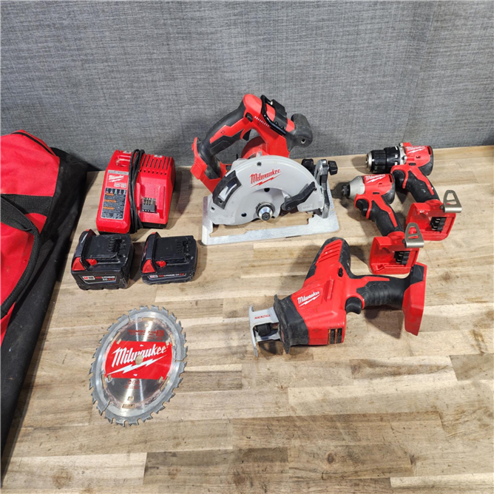 HOUSTON LOCATION - AS-IS Milwaukee M18 18-Volt Lithium-Ion Brushless Cordless Combo Kit (4-Tool) with 2-Batteries, 1-Charger and Tool Bag