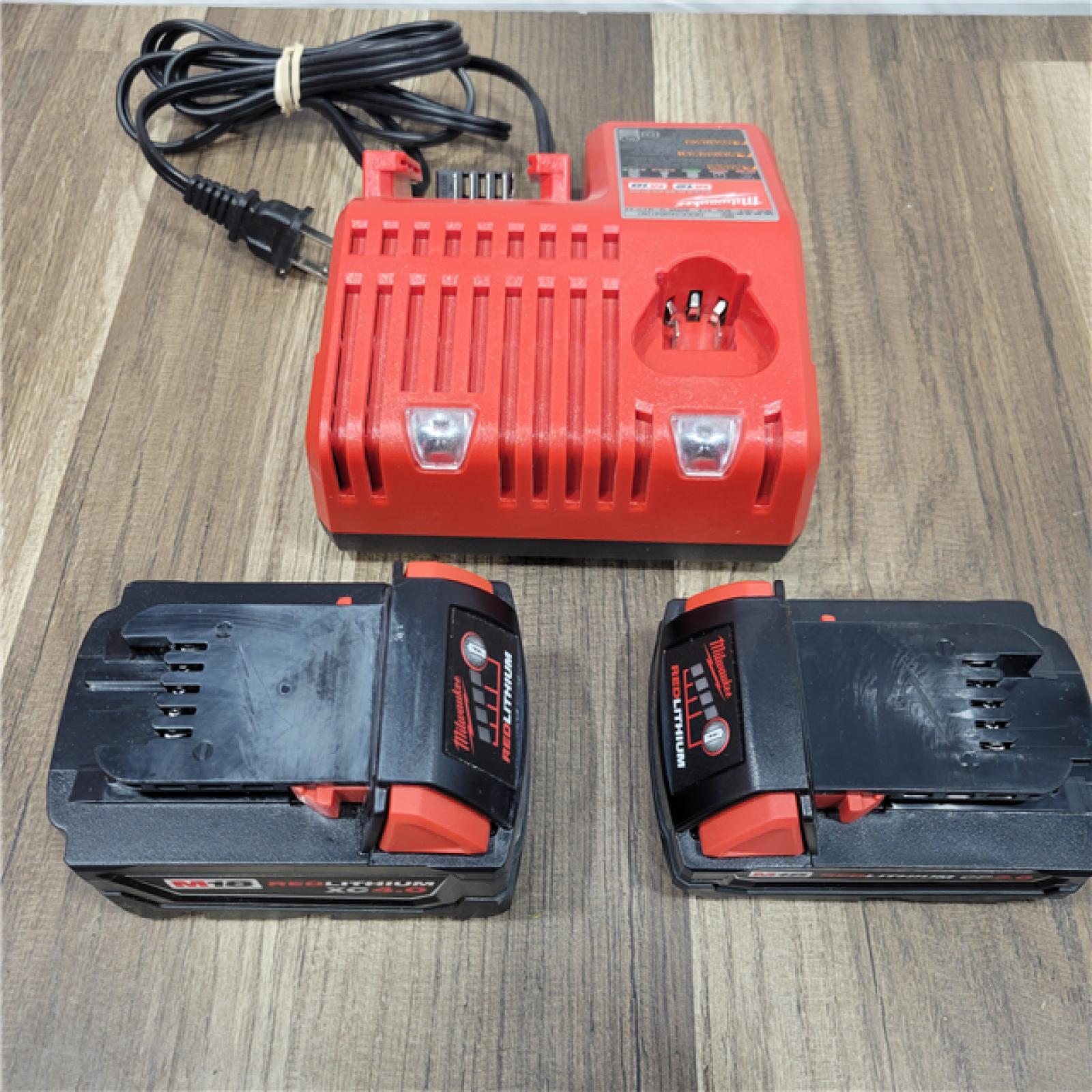 AS-IS Milwaukee M18 18-Volt Lithium-Ion Brushless Cordless Combo Kit (4-Tool) with 2-Batteries, 1-Charger and Tool Bag