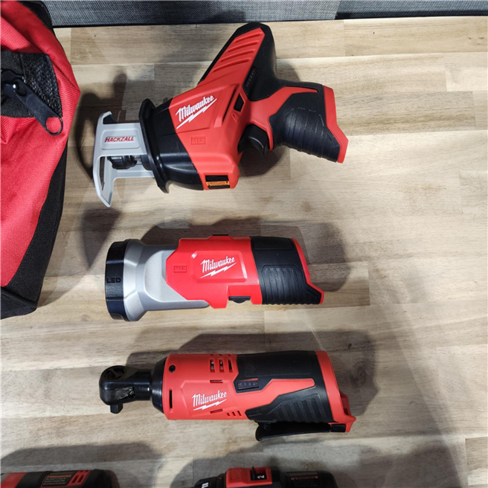 HOUSTON LOCATION - AS-IS (APPEARS LIKE NEW) MILWAUKEE M12 12V Lithium-Ion Cordless Combo Kit (5-Tool) with Two 1.5Ah Batteries, Charger & Tool Bag