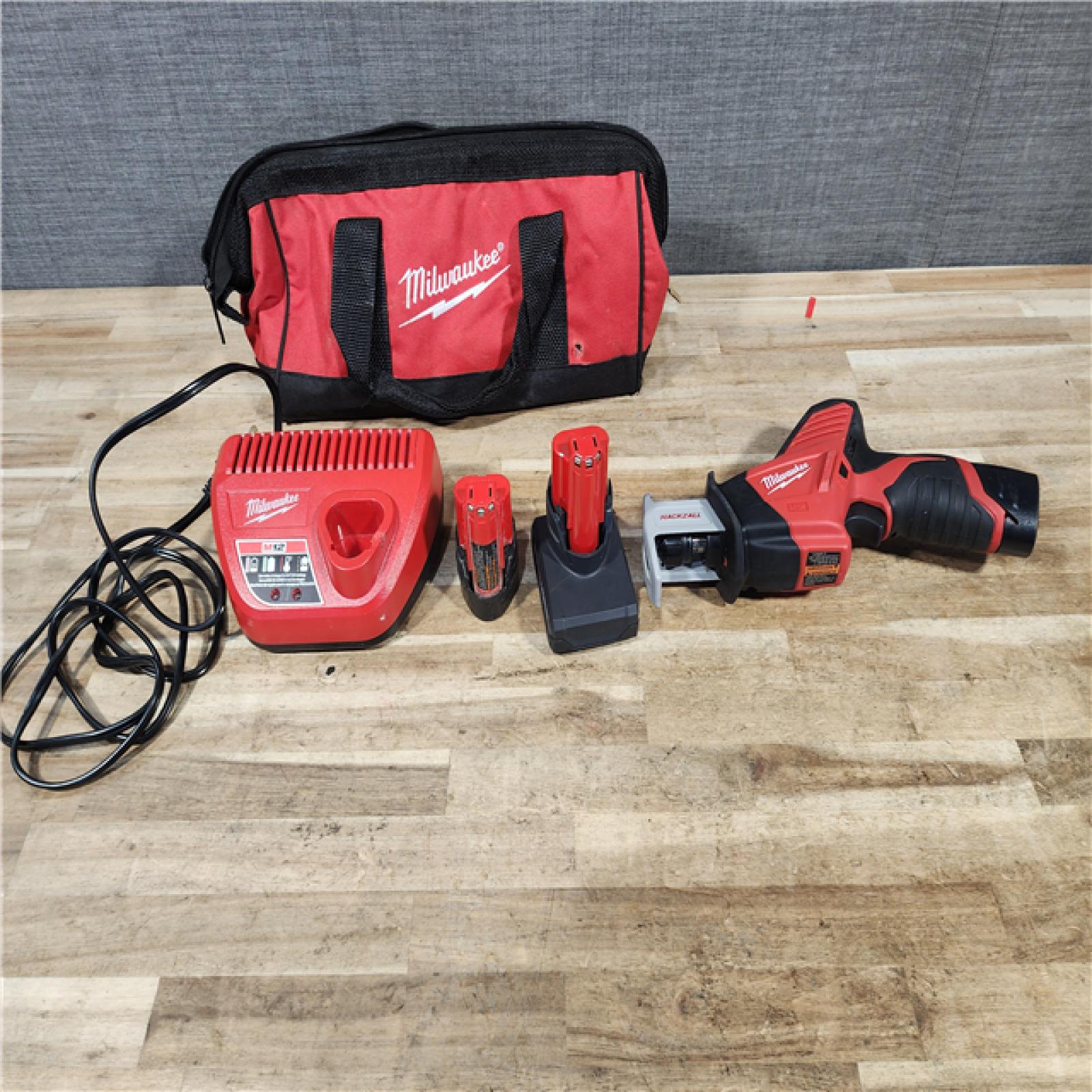 HOUSTON LOCATION - AS - IS Milwaukee M12 12-Volt Lithium-Ion HACKZALL Cordless Reciprocating Saw W/ (2) Batteries  Charger and Bag