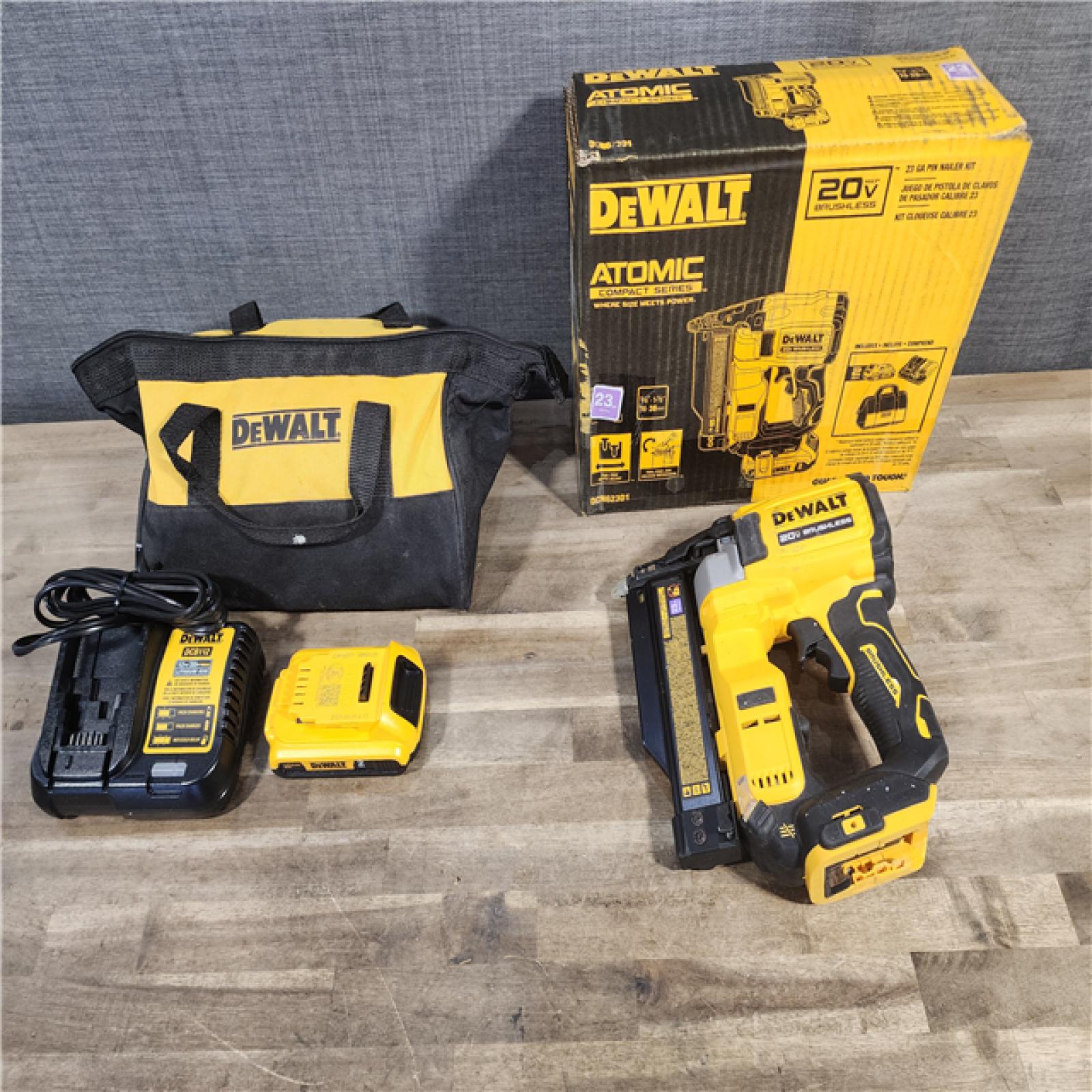 HOUSTON LOCATION - AS-IS DEWALT ATOMIC 20V MAX Lithium Ion Cordless 23 Gauge Pin Nailer Kit with 2.0Ah Battery and Charger