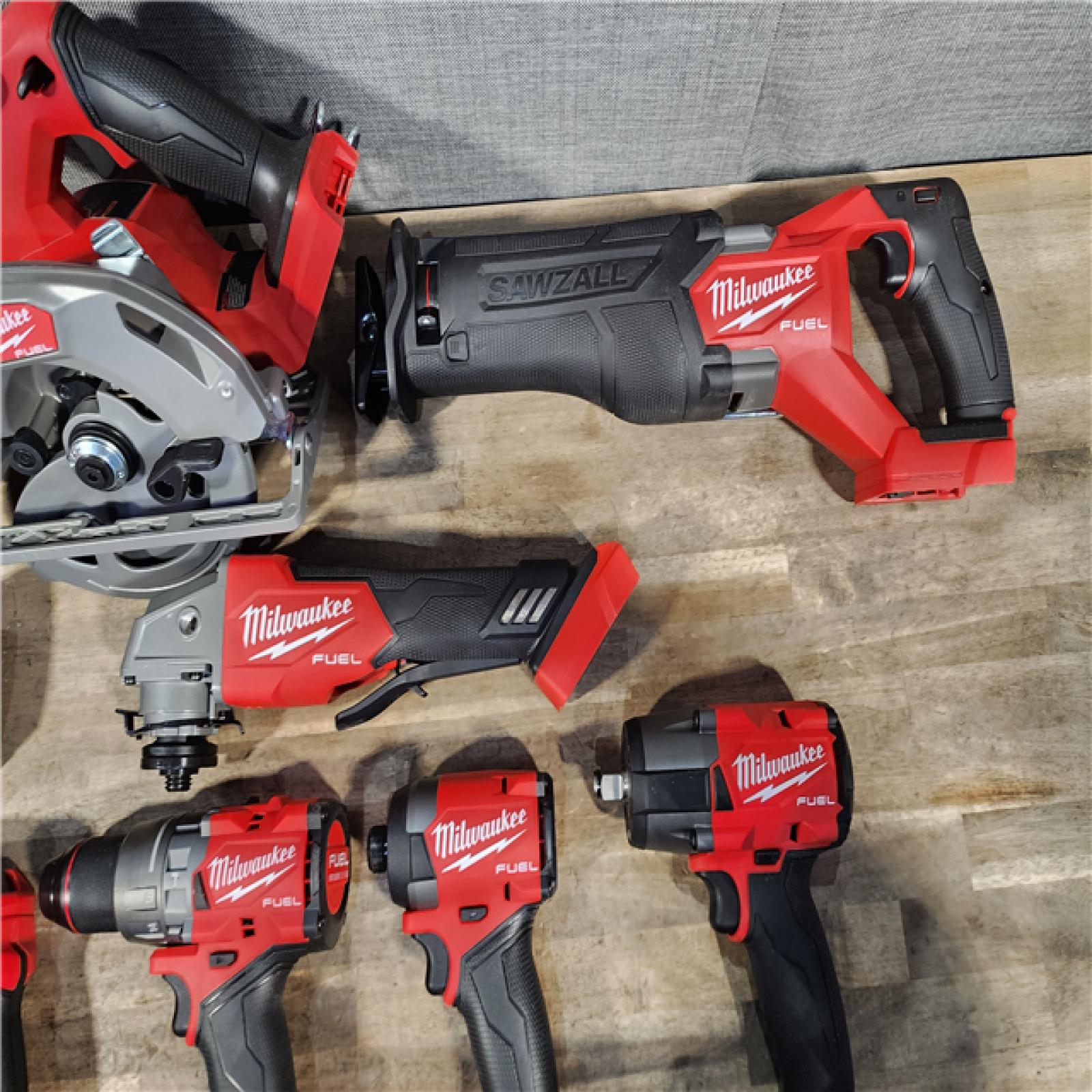 HOUSTON LOCATION - AS-IS (APPEARS LIKE NEW) Milwaukee M18 FUEL 18V Lithium-Ion Brushless Cordless Combo Kit with Two 5.0 Ah Batteries  1 Charger  2 Tool Bags (7-Tool)