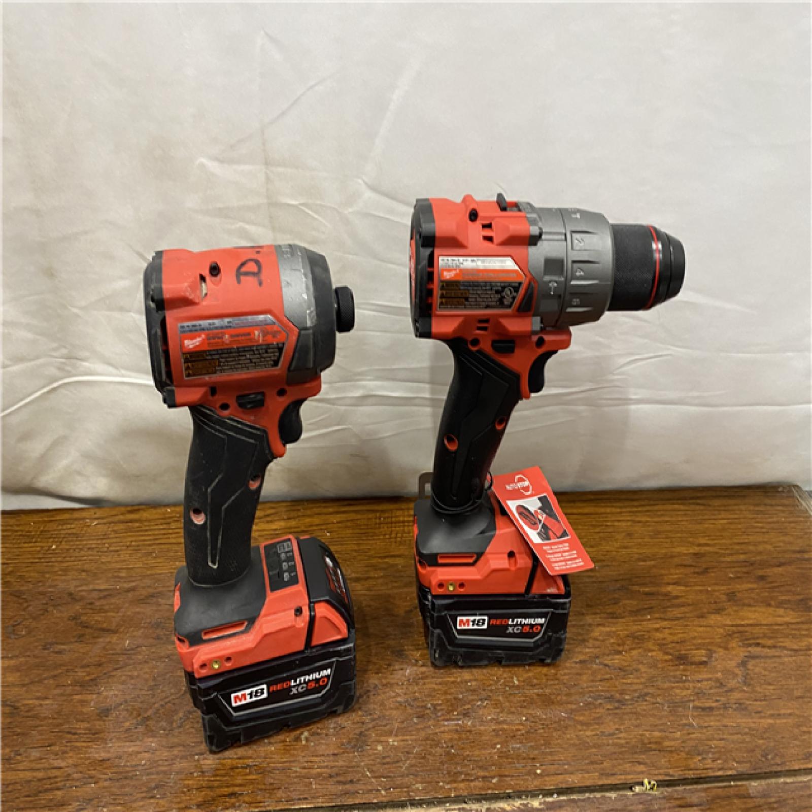 AS-IS MILWAUKEE M18 FUEL 18V Lithium-Ion Brushless Cordless Hammer Drill and Impact Driver Combo Kit (2-Tool) with 2 Batteries
