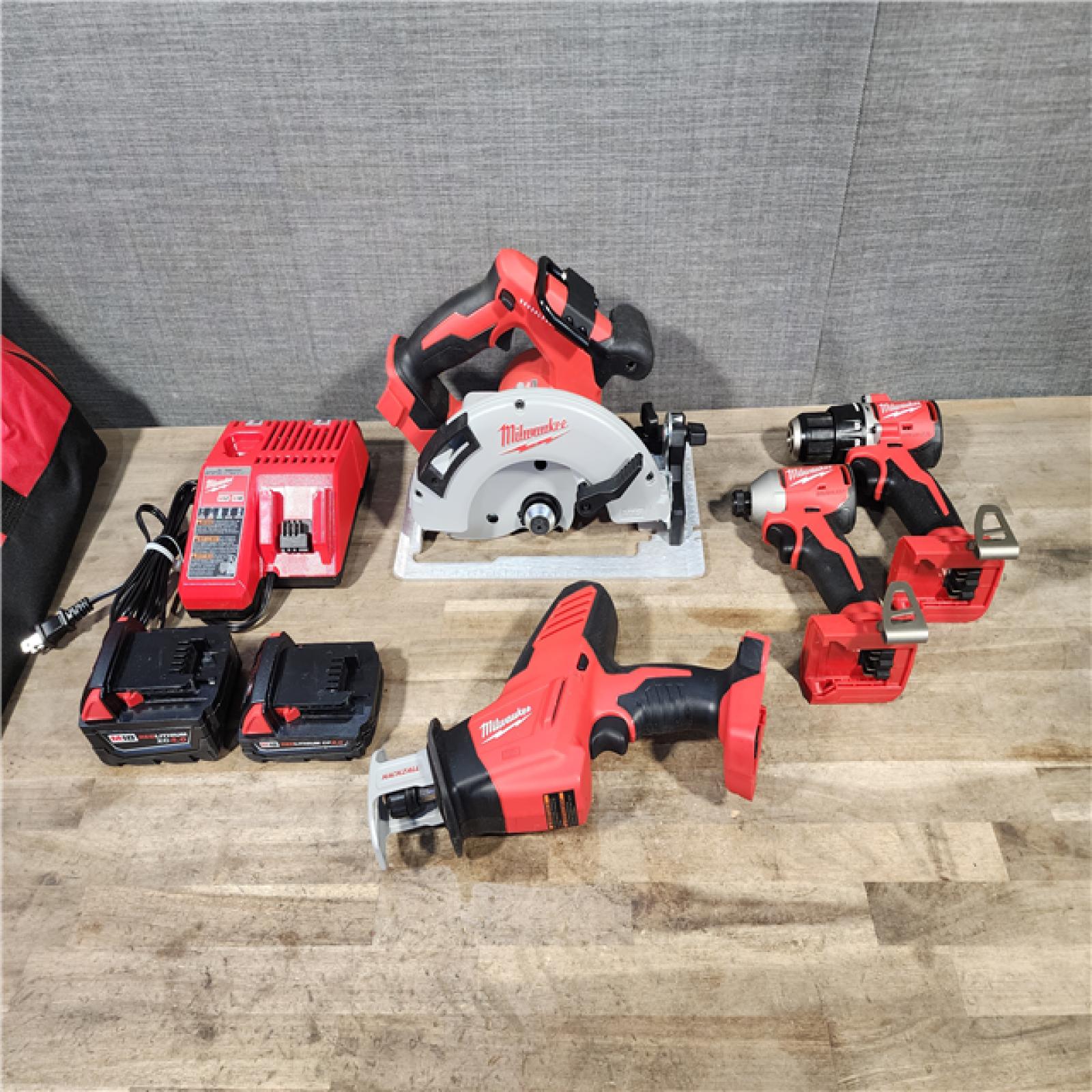 HOUSTON LOCATION - AS-IS Milwaukee M18 18-Volt Lithium-Ion Brushless Cordless Combo Kit (4-Tool) with 2-Batteries  1-Charger and Tool Bag