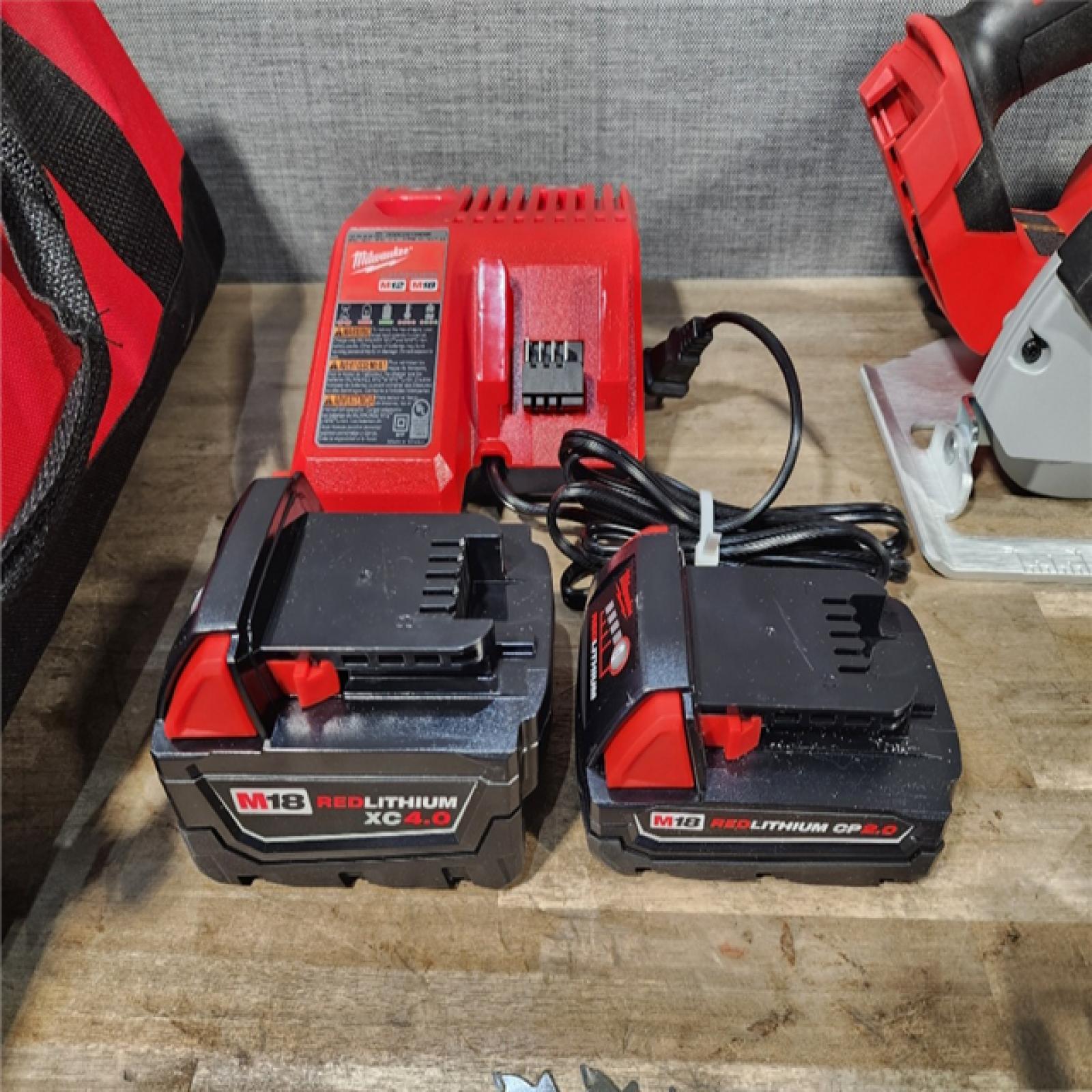 HOUSTON LOCATION - AS-IS Milwaukee M18 18-Volt Lithium-Ion Brushless Cordless Combo Kit (4-Tool) with 2-Batteries, 1-Charger and Tool Bag