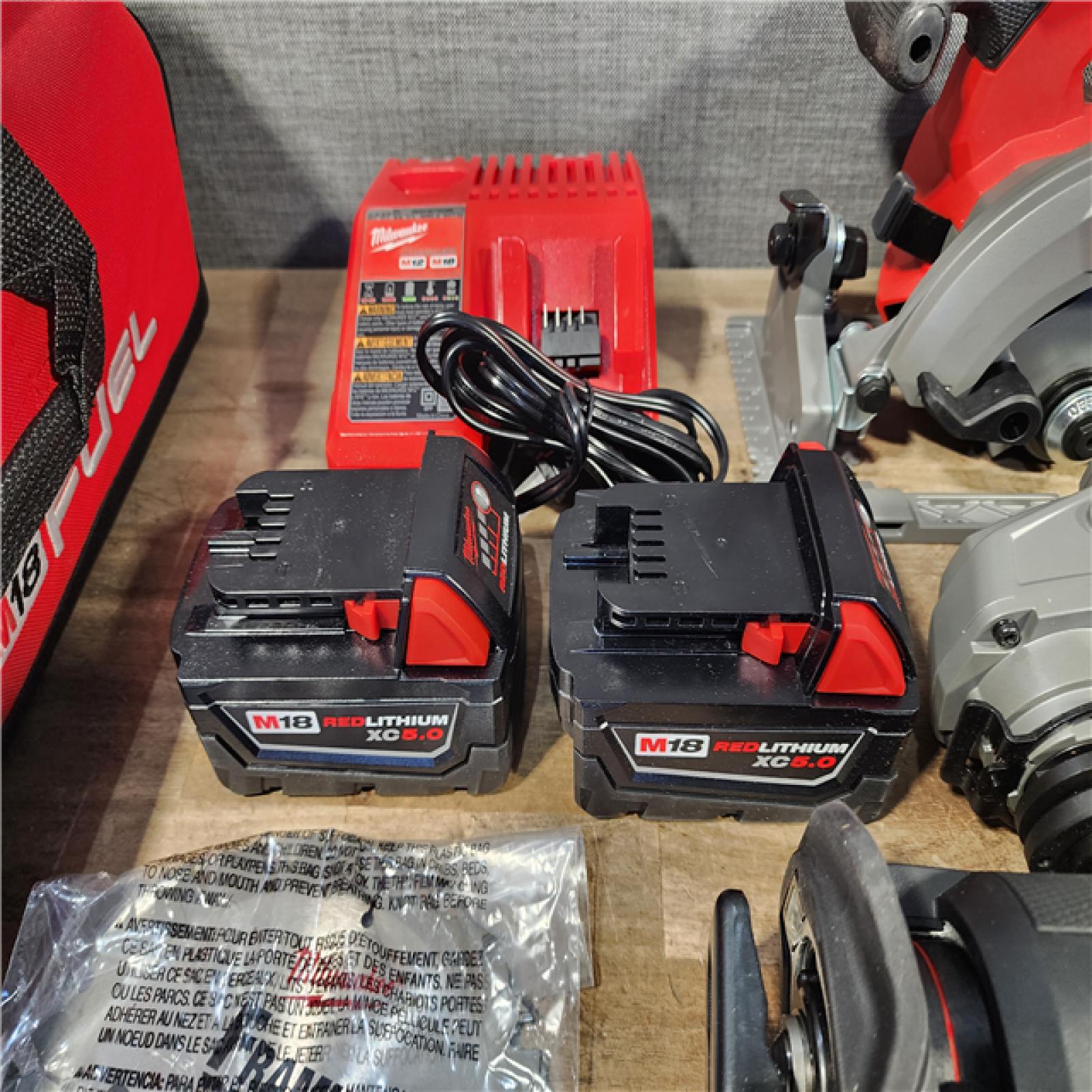 HOUSTON LOCATION - AS-IS Milwaukee M18 FUEL 18V Lithium-Ion Brushless Cordless Combo Kit with Two 5.0 Ah Batteries  1 Charger  2 Tool Bags (7-Tool)