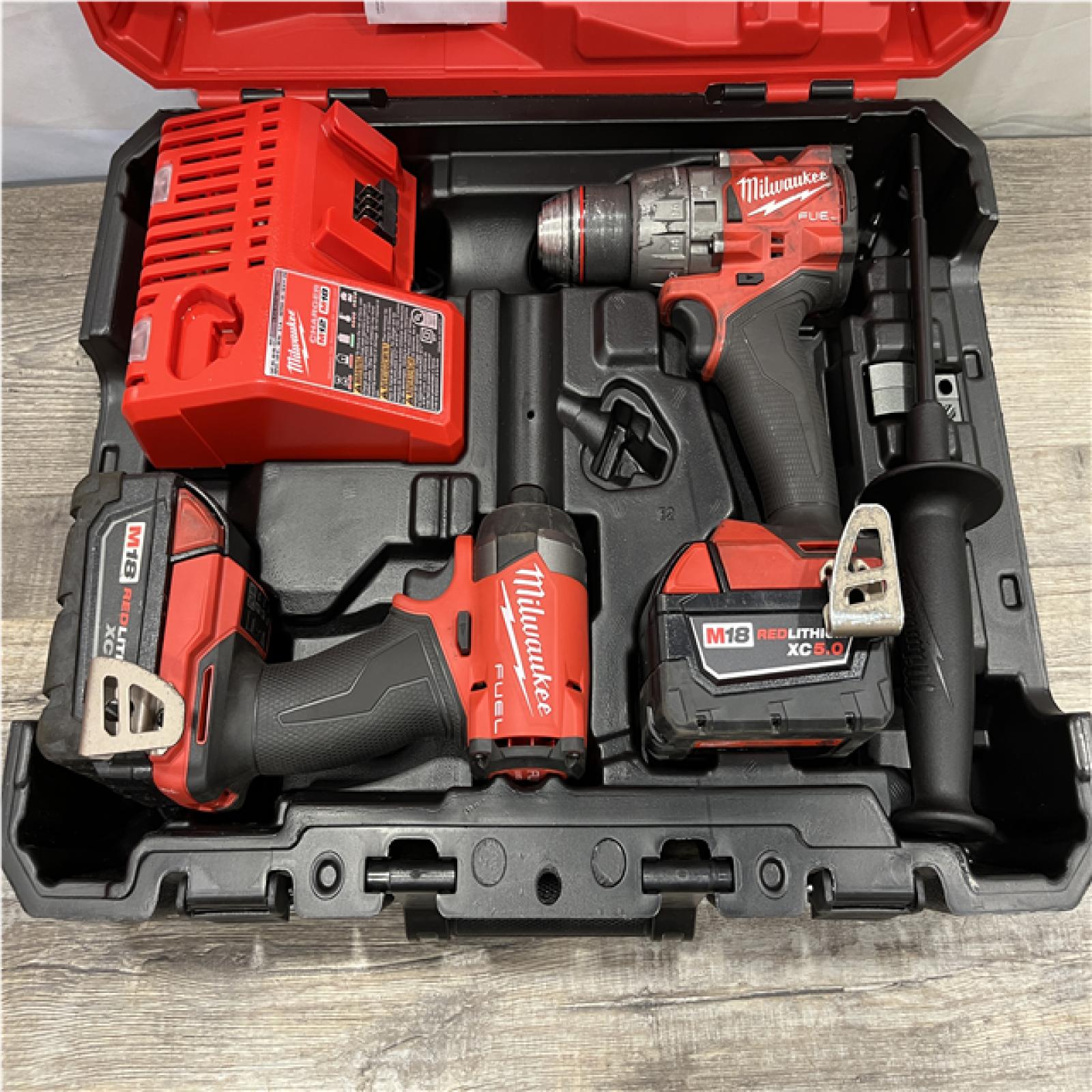 AS-IS Milwaukee FUEL 18V Lithium-Ion Brushless Cordless Hammer Drill and Impact Driver Combo Kit