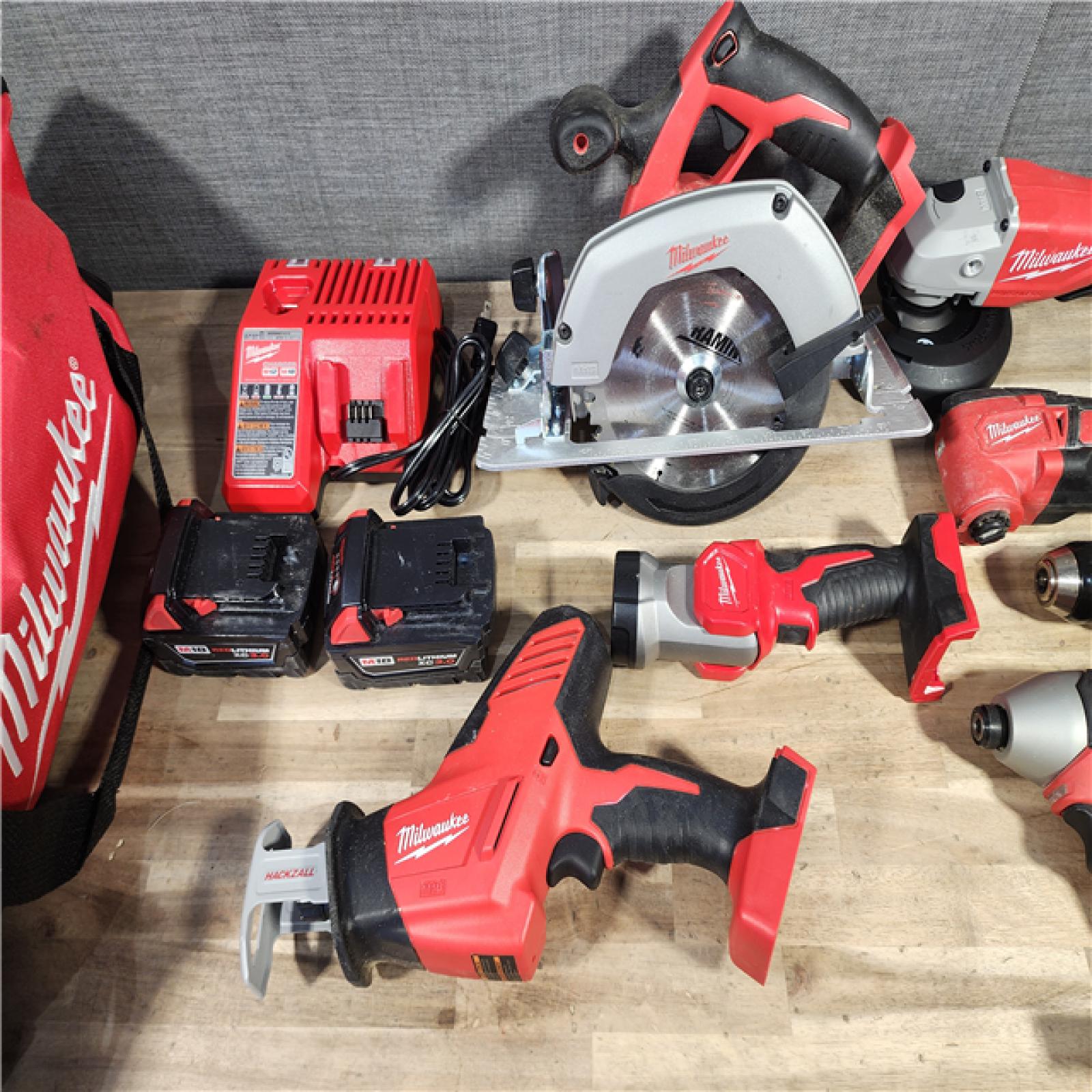 HOUSTON LOCATION - AS-IS Milwaukee M18 18-Volt Lithium-Ion Cordless Combo Kit 7-Tool with 2-Batteries, Charger and Tool Bag