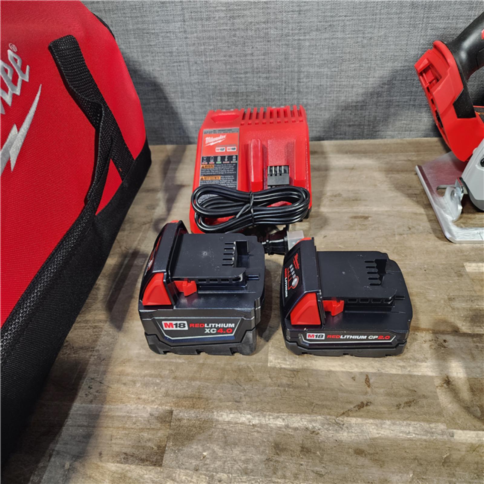 HOUSTON LOCATION - AS-IS Milwaukee M18 18-Volt Lithium-Ion Brushless Cordless Combo Kit (4-Tool) with 2-Batteries  1-Charger and Tool Bag