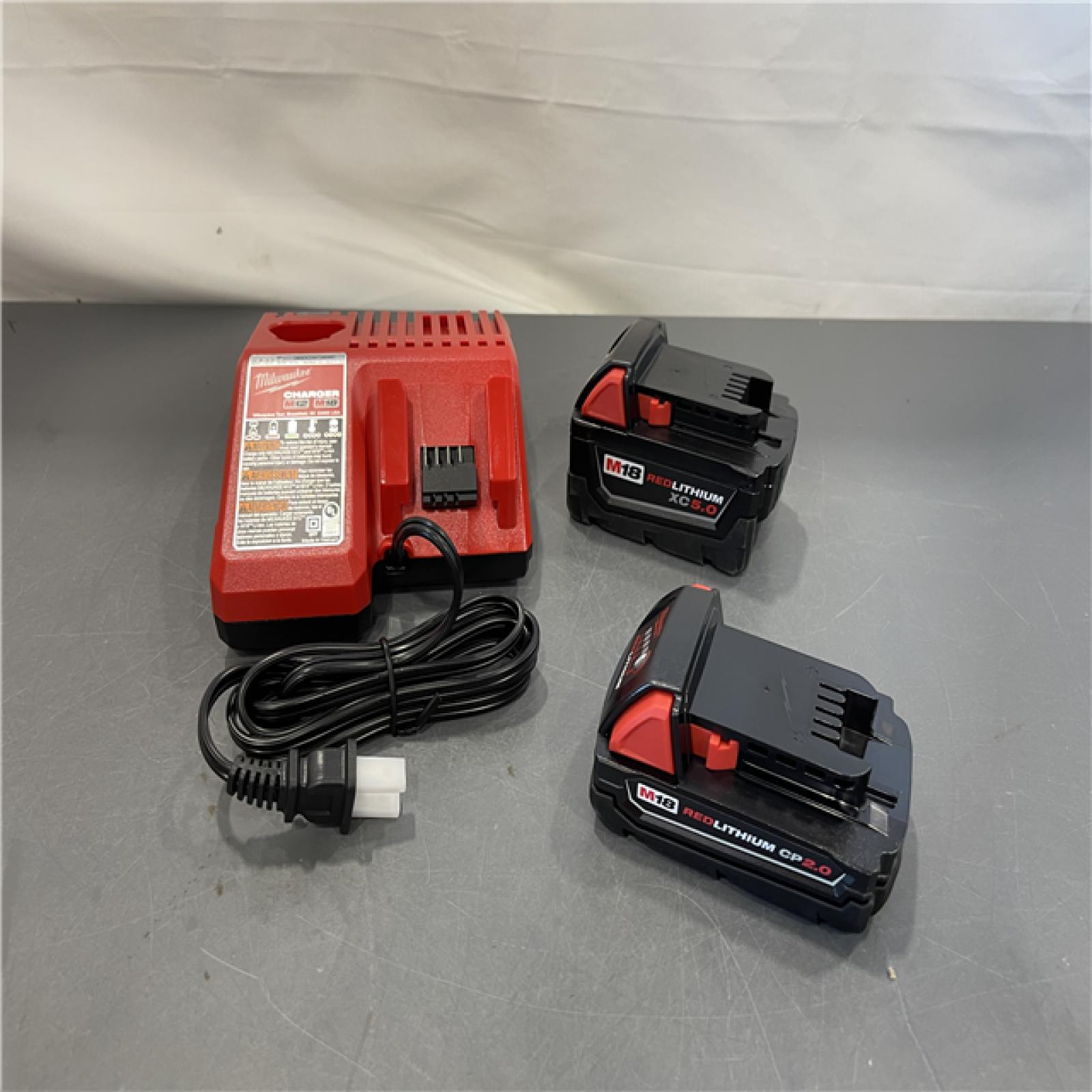 AS-IS - Milwaukee M18 Volt Lithium-Ion Starter Kit with One 5.0 Ah and One 2.0 Ah Battery and Charger