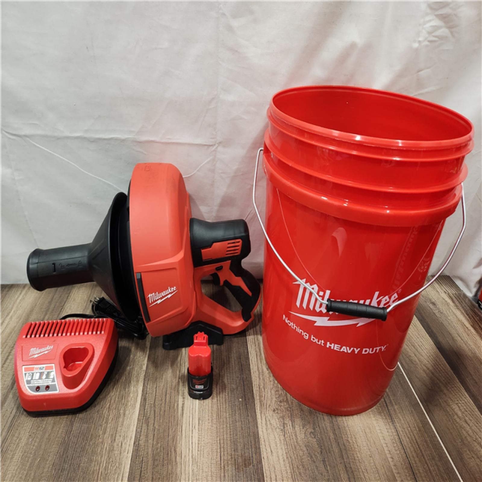 AS-IS- M12 12-V Lithium-Ion Cordless Drain Snake Auger W/ (1) 1.5Ah Battery  5/16 in. X 25 Ft. Cable  Charger  & 5 Gal. Bucket