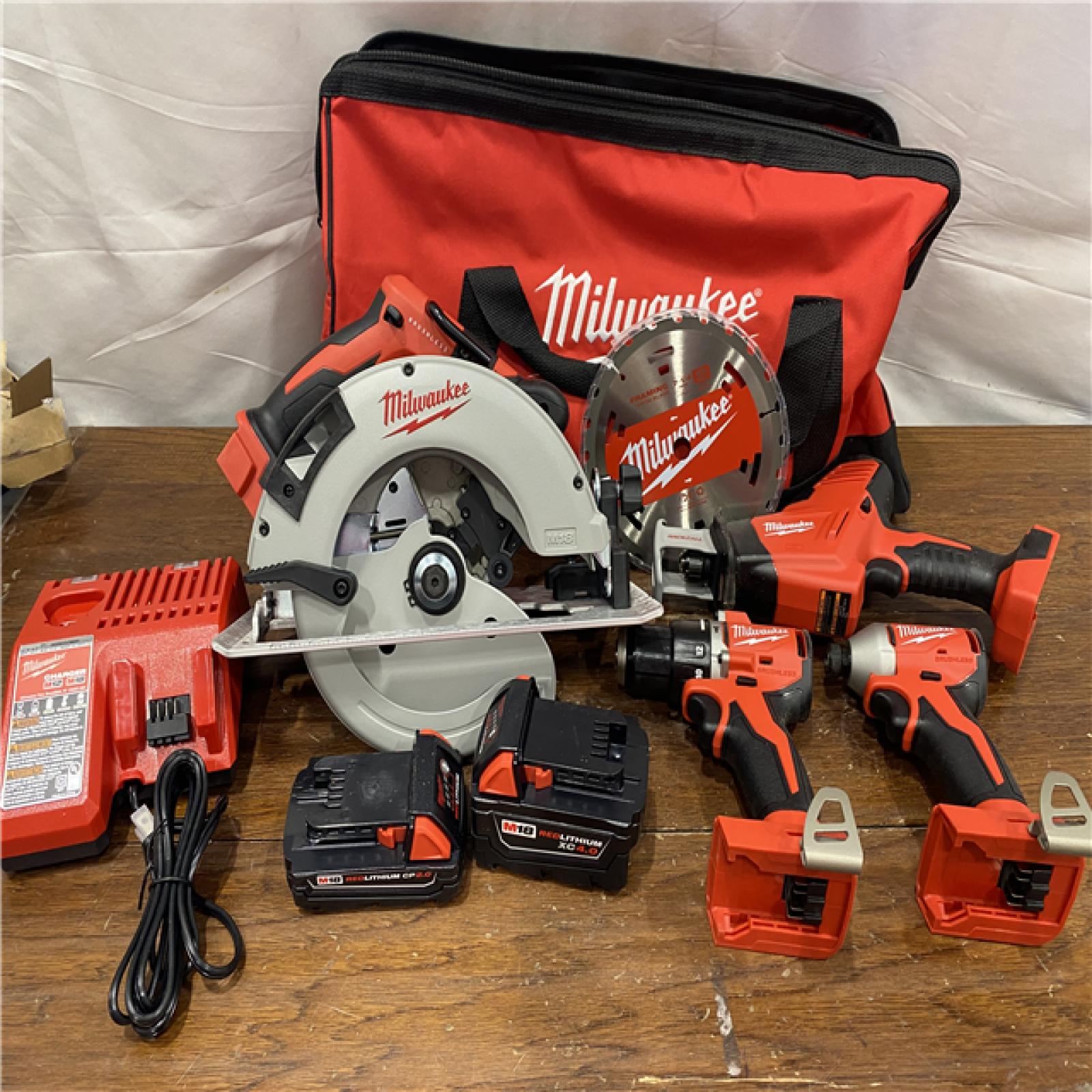 AS-IS Milwaukee M18 18-Volt Lithium-Ion Brushless Cordless Combo Kit (4-Tool) with 2-Batteries, 1-Charger and Tool Bag