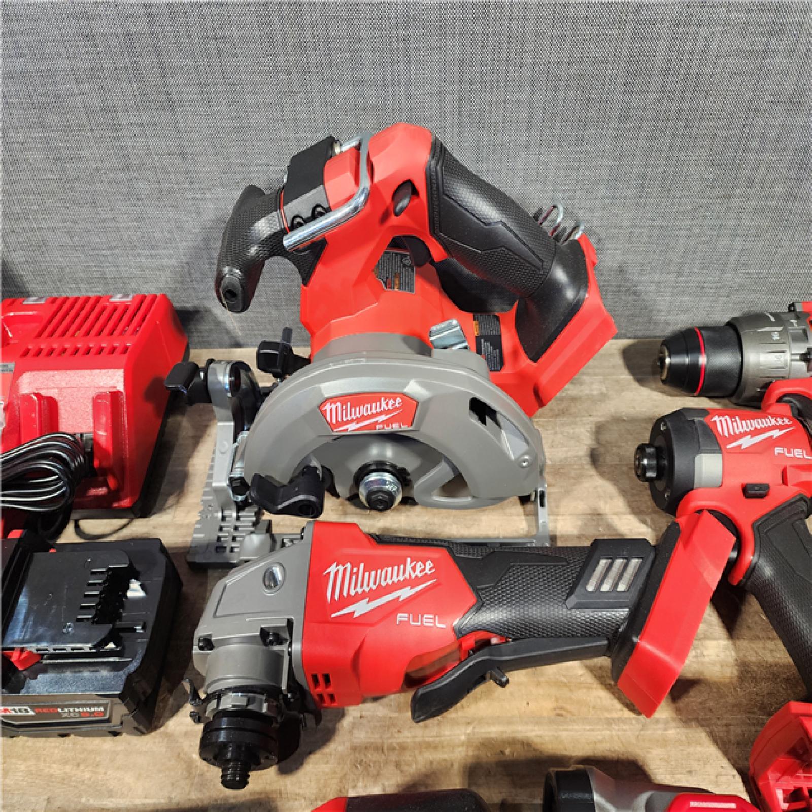 HOUSTON LOCATION - AS-IS (APPEARS LIKE NEW) Milwaukee M18 FUEL 18V Lithium-Ion Brushless Cordless Combo Kit with Two 5.0 Ah Batteries  1 Charger  2 Tool Bags (7-Tool)