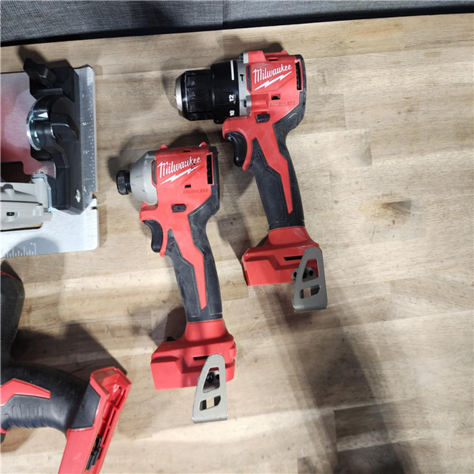 HOUSTON LOCATION - AS-IS Milwaukee M18 18-Volt Lithium-Ion Brushless Cordless Combo Kit (4-Tool) with 2-Batteries, 1-Charger and Tool Bag