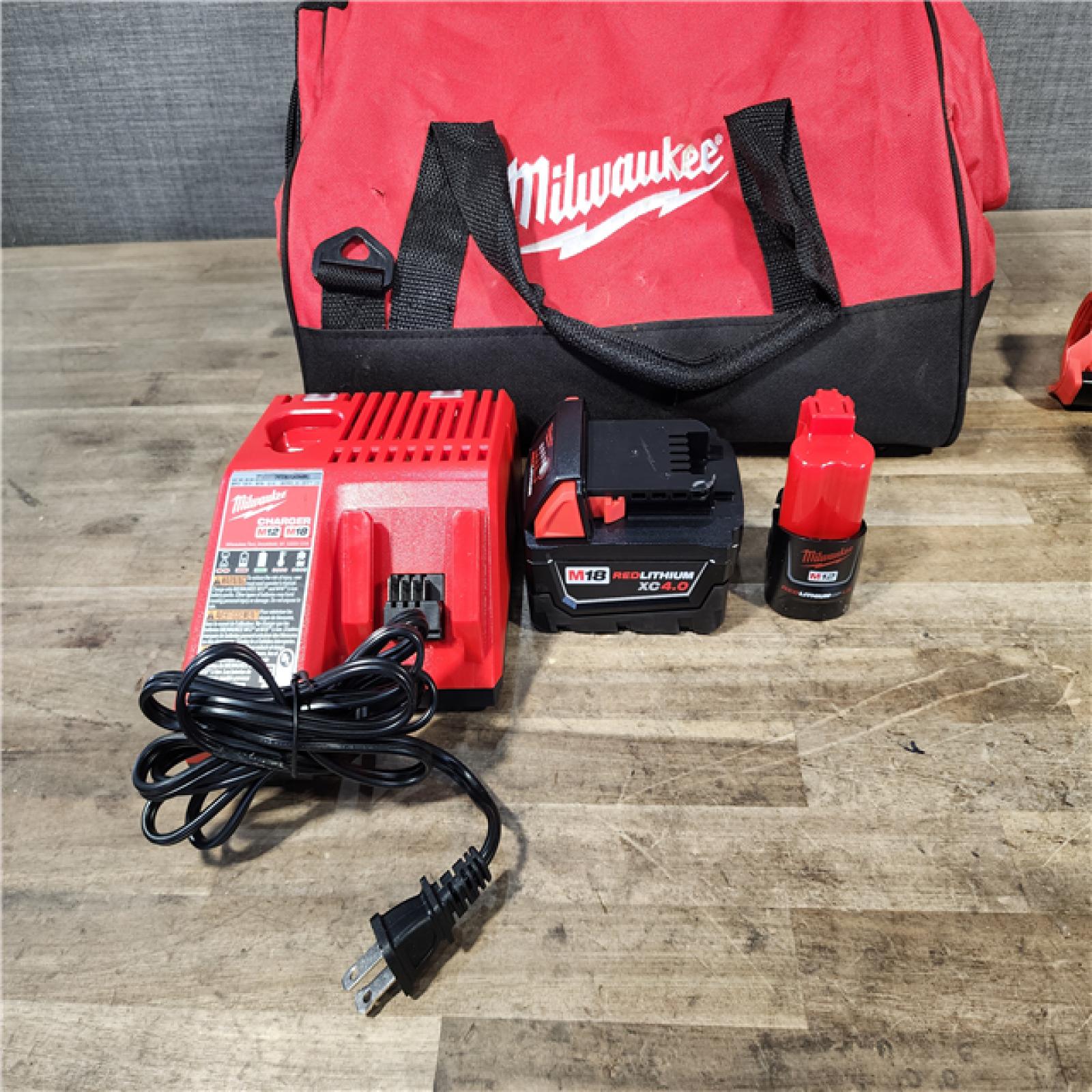 HOUSTON LOCATION - AS-IS Milwaukee 12/18V Lithium-Ion Cordless 3/8 in. Ratchet and 1/2 in. High Torque Impact Wrench with Friction Ring Combo Kit