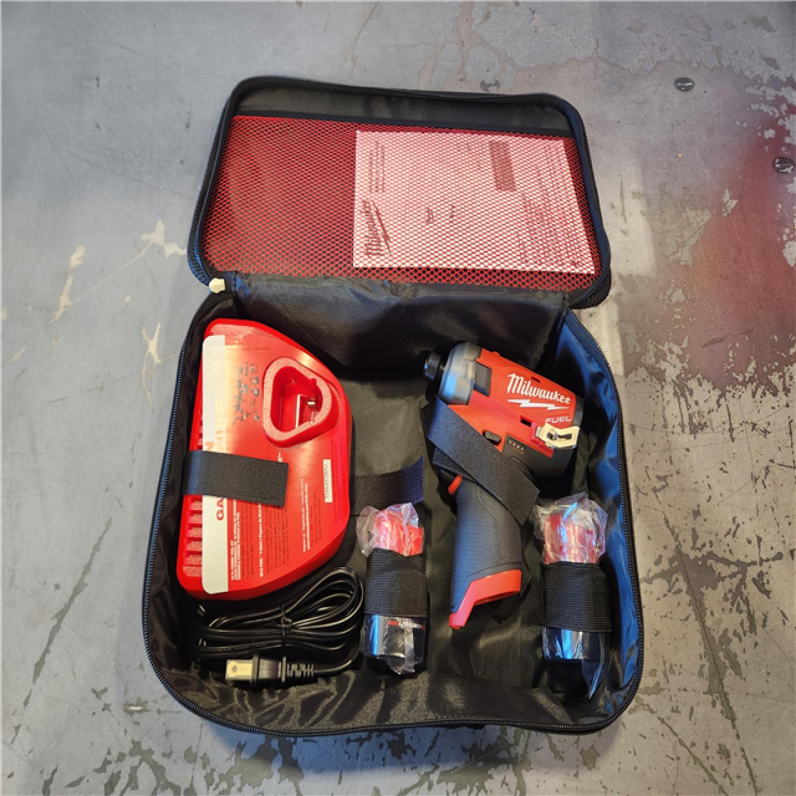 AS-IS - Milwaukee M12 FUEL SURGE 12V Lithium-Ion Brushless Cordless 1/4 in. Hex Impact Driver Compact Kit W/Two 2.0Ah Batteries, Bag