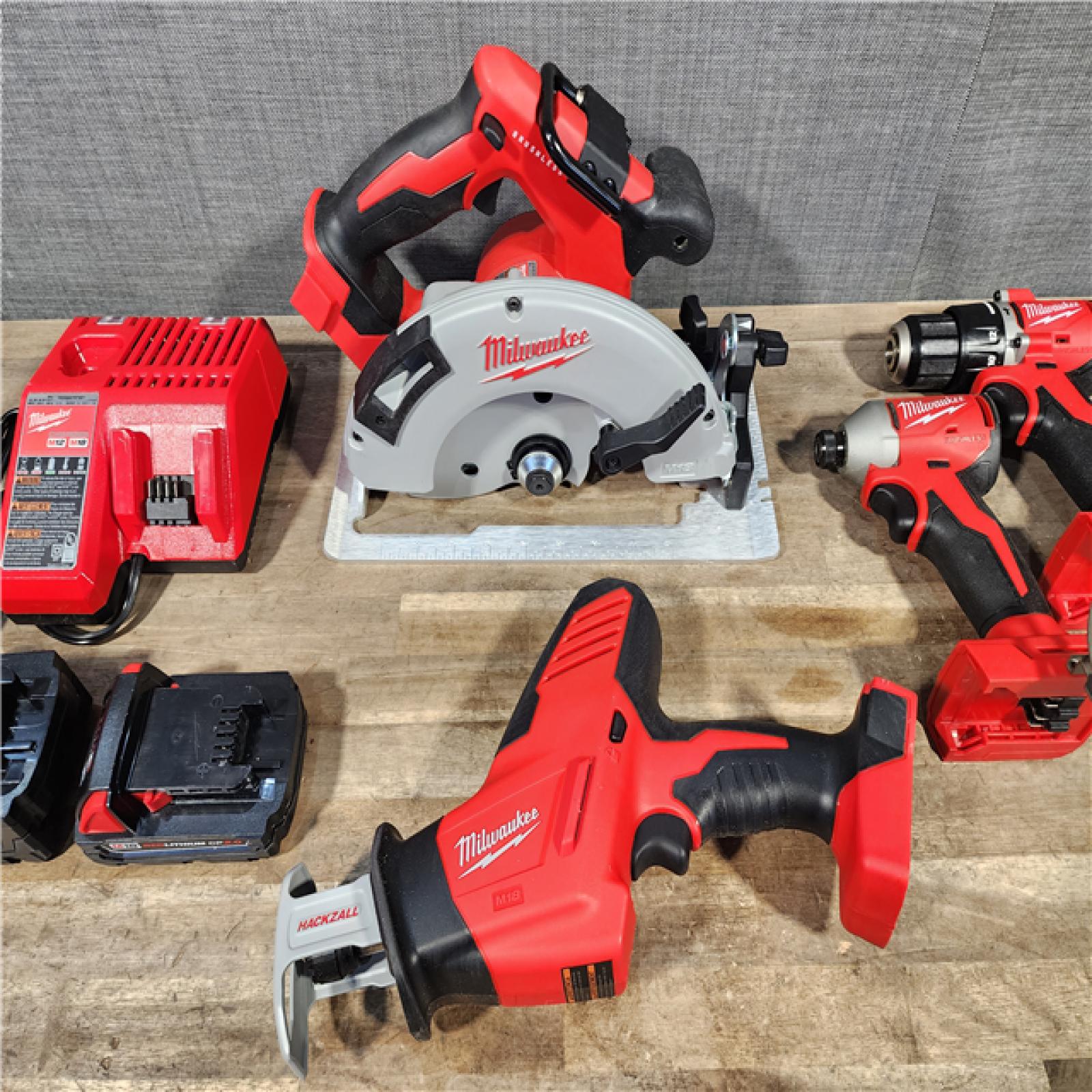 HOUSTON LOCATION - AS-IS Milwaukee M18 18-Volt Lithium-Ion Brushless Cordless Combo Kit (4-Tool) with 2-Batteries  1-Charger and Tool Bag