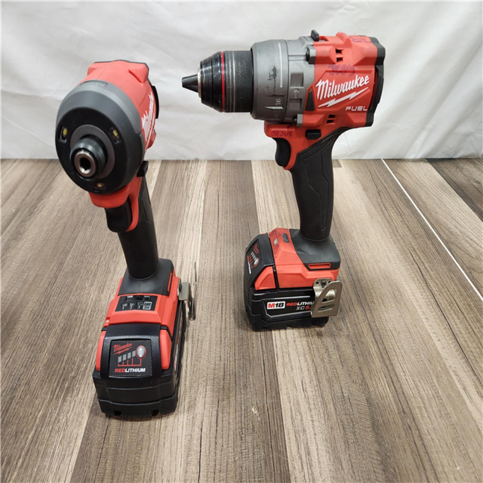 AS-IS MILWAUKEE FUEL 18V Lithium-Ion Brushless Cordless Hammer Drill and Impact Driver Combo Kit (2-Tool) with 2 Batteries