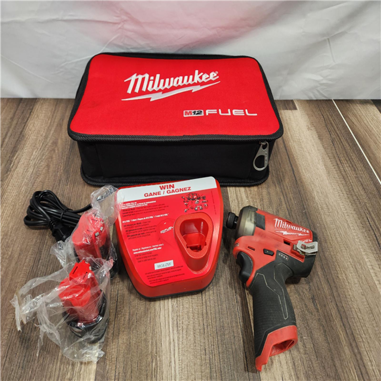 AS-IS - Milwaukee M12 FUEL SURGE 12V Lithium-Ion Brushless Cordless 1/4 in. Hex Impact Driver Compact Kit